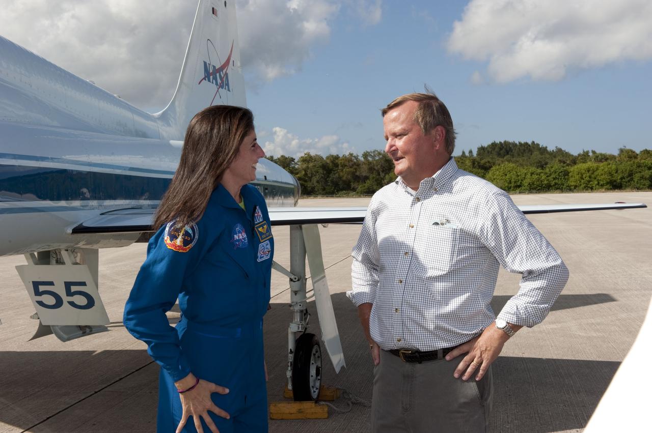 CAPE CANAVERAL, Fla. -- At NASA's Kennedy Space Center in Florida, space shuttle Discovery's STS-133 Mission Specialist Nicole Stott, left, is greeted by Shuttle Launch Director Mike Leinbach on the Shuttle Landing Facility runway after arriving in a T-38 training jet. In the days leading up to their launch to the International Space Station, Stott and her crew members will check the fit of their launch-and-entry suits, review launch-day procedures, receive weather briefings and remain medically quarantined to prevent sickness.      Scheduled to lift off Nov. 1 at 4:40 p.m., Discovery and crew will deliver the Permanent Multipurpose Module, packed with supplies and critical spare parts, as well as Robonaut 2, the dexterous humanoid astronaut helper, to the orbiting outpost. For more information on the STS-133 mission, visit www.nasa.gov/mission_pages/shuttle/shuttlemissions/sts133/. Photo credit: NASA/Jack Pfaller