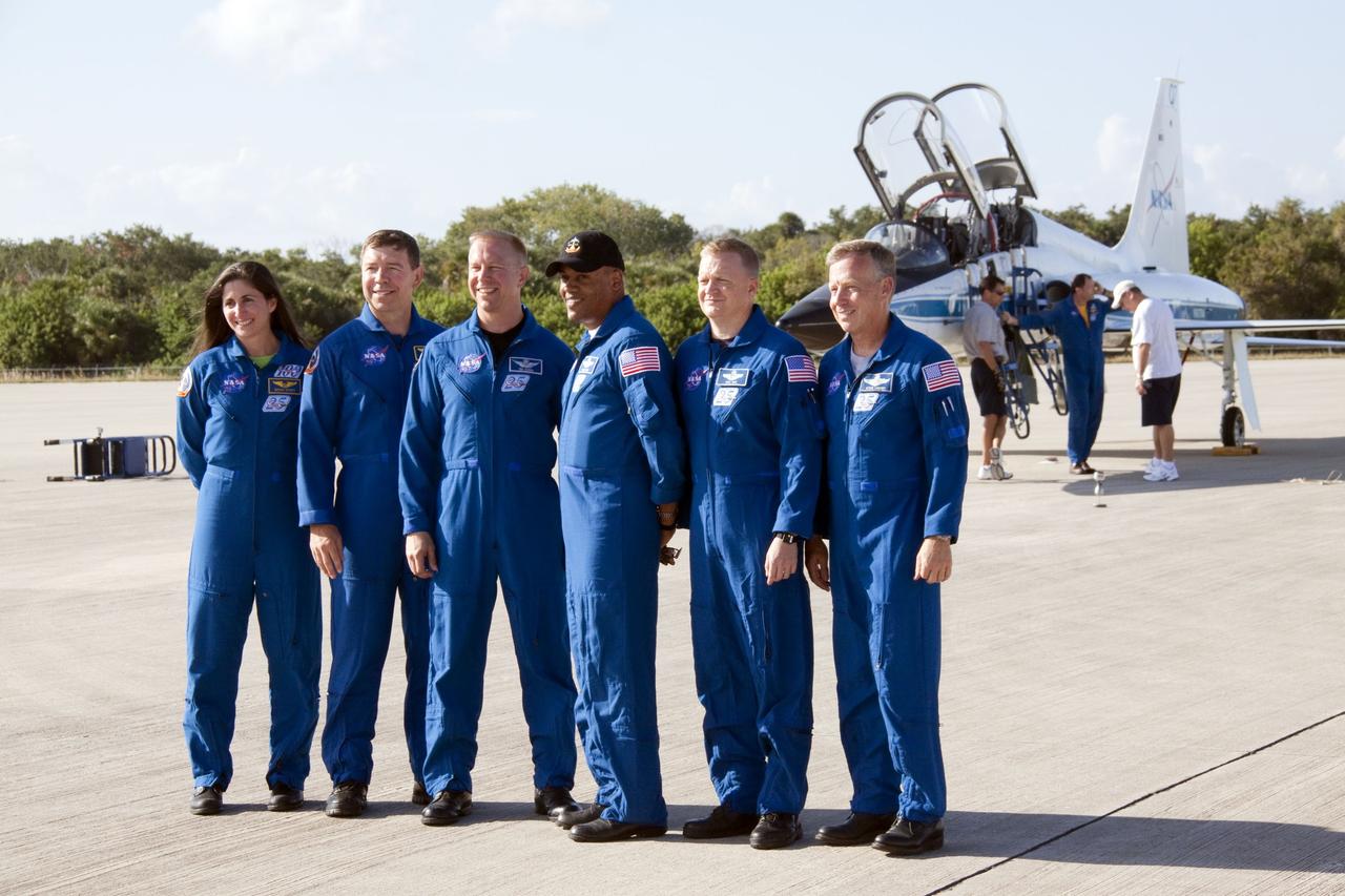 CAPE CANAVERAL, Fla. -- At NASA's Kennedy Space Center in Florida, space shuttle Discovery's STS-133 crew poses for a group photo on the Shuttle Landing Facility runway after arriving aboard T-38 training jets. From left are Mission Specialists Nicole Stott, Michael Barratt, Tim Kopra and Alvin Drew, Pilot Eric Boe, and Commander Steve Lindsey. In the days leading up to their launch to the International Space Station, the crew members will check the fit of their launch-and-entry suits, review launch-day procedures, receive weather briefings and remain medically quarantined to prevent sickness.    Scheduled to lift off Nov. 1 at 4:40 p.m., Discovery and crew will deliver the Permanent Multipurpose Module, packed with supplies and critical spare parts, as well as Robonaut 2, the dexterous humanoid astronaut helper, to the orbiting outpost. For more information on the STS-133 mission, visit www.nasa.gov/mission_pages/shuttle/shuttlemissions/sts133/. Photo credit: NASA/Jack Pfaller