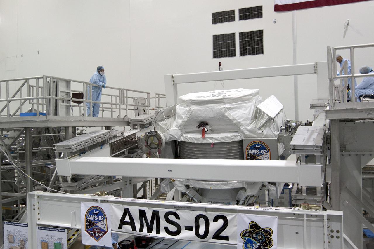 CAPE CANAVERAL, Fla. -- In the Space Station Processing Facility at NASA's Kennedy Space Center in Florida, the Alpha Magnetic Spectrometer-2 (AMS) begins a 180-degree rotation to provide better access for work to be performed on its avionics box. Technicians also will install a flight releasable grappling fixture to AMS while it is upside down. AMS is designed to operate as an external experiment on the International Space Station. It will use the unique environment of space to study the universe and its origin by searching for dark matter. AMS will fly to the station aboard space shuttle Endeavour's STS-134 mission targeted to launch Feb. 27, 2011. Photo credit: NASA/Jack Pfaller