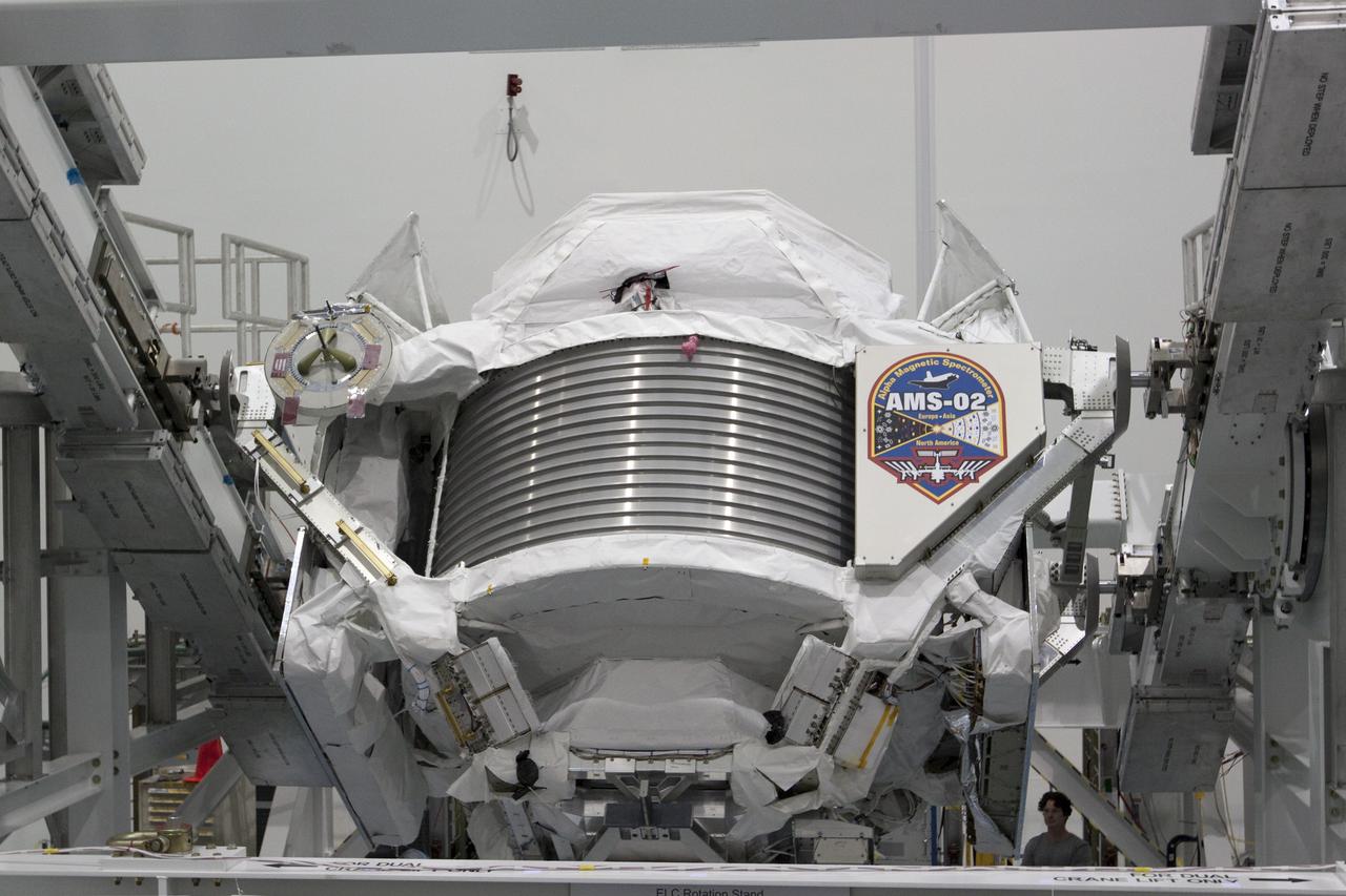 CAPE CANAVERAL, Fla. -- In the Space Station Processing Facility at NASA's Kennedy Space Center in Florida, the Alpha Magnetic Spectrometer-2 (AMS) rotates 180 degrees to provide better access for work to be performed on its avionics box. Technicians also will install a flight releasable grappling fixture to AMS while it is upside down. AMS is designed to operate as an external experiment on the International Space Station. It will use the unique environment of space to study the universe and its origin by searching for dark matter. AMS will fly to the station aboard space shuttle Endeavour's STS-134 mission targeted to launch Feb. 27, 2011. Photo credit: NASA/Jack Pfaller