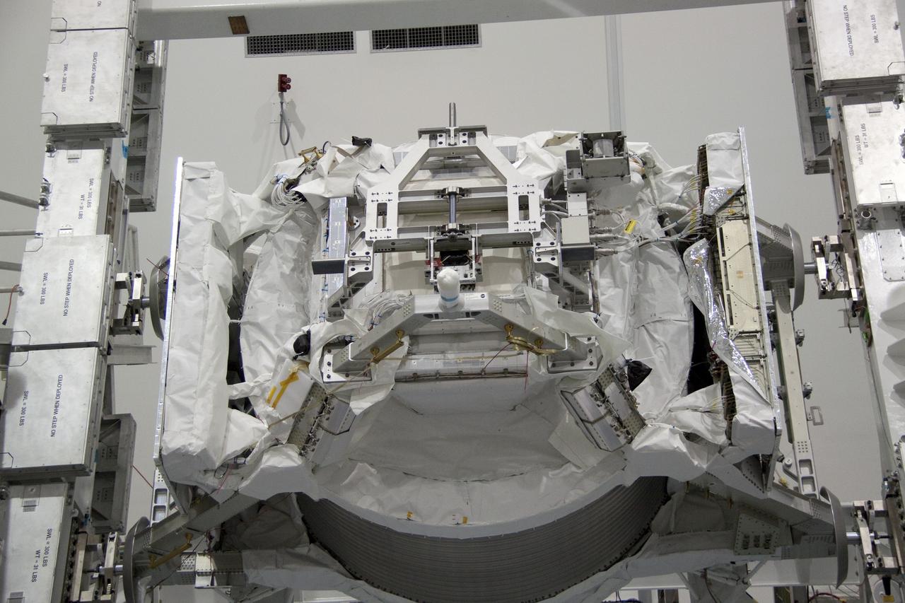 CAPE CANAVERAL, Fla. -- In the Space Station Processing Facility at NASA's Kennedy Space Center in Florida, the Alpha Magnetic Spectrometer-2 (AMS) rotates 180 degrees to provide better access for work to be performed on its avionics box. Technicians also will install a flight releasable grappling fixture to AMS while it is upside down. AMS is designed to operate as an external experiment on the International Space Station. It will use the unique environment of space to study the universe and its origin by searching for dark matter. AMS will fly to the station aboard space shuttle Endeavour's STS-134 mission targeted to launch Feb. 27, 2011. Photo credit: NASA/Jack Pfaller