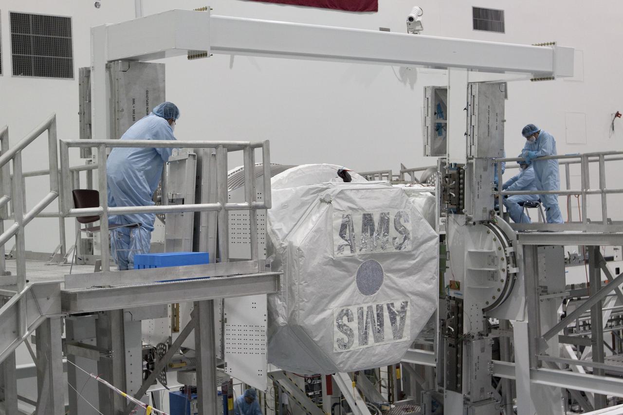 CAPE CANAVERAL, Fla. -- In the Space Station Processing Facility at NASA's Kennedy Space Center in Florida, the Alpha Magnetic Spectrometer-2 (AMS) rotates 180 degrees to provide better access for work to be performed on its avionics box. Technicians also will install a flight releasable grappling fixture to AMS while it is upside down. AMS is designed to operate as an external experiment on the International Space Station. It will use the unique environment of space to study the universe and its origin by searching for dark matter. AMS will fly to the station aboard space shuttle Endeavour's STS-134 mission targeted to launch Feb. 27, 2011. Photo credit: NASA/Jack Pfaller