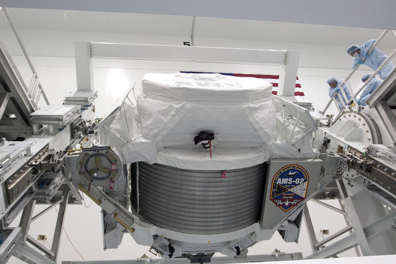 CAPE CANAVERAL, Fla. -- In the Space Station Processing Facility at NASA's Kennedy Space Center in Florida, the Alpha Magnetic Spectrometer-2 (AMS) rotates 180 degrees to provide better access for work to be performed on its avionics box. Technicians also will install a flight releasable grappling fixture to AMS while it is upside down. AMS is designed to operate as an external experiment on the International Space Station. It will use the unique environment of space to study the universe and its origin by searching for dark matter. AMS will fly to the station aboard space shuttle Endeavour's STS-134 mission targeted to launch Feb. 27, 2011. Photo credit: NASA/Jack Pfaller