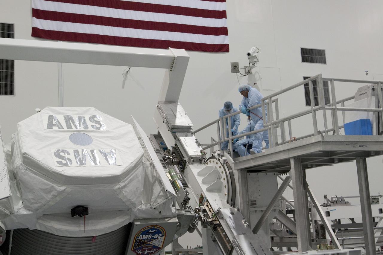 CAPE CANAVERAL, Fla. -- In the Space Station Processing Facility at NASA's Kennedy Space Center in Florida, the Alpha Magnetic Spectrometer-2 (AMS) rotates 180 degrees to provide better access for work to be performed on its avionics box. Technicians also will install a flight releasable grappling fixture to AMS while it is upside down. AMS is designed to operate as an external experiment on the International Space Station. It will use the unique environment of space to study the universe and its origin by searching for dark matter. AMS will fly to the station aboard space shuttle Endeavour's STS-134 mission targeted to launch Feb. 27, 2011. Photo credit: NASA/Jack Pfaller