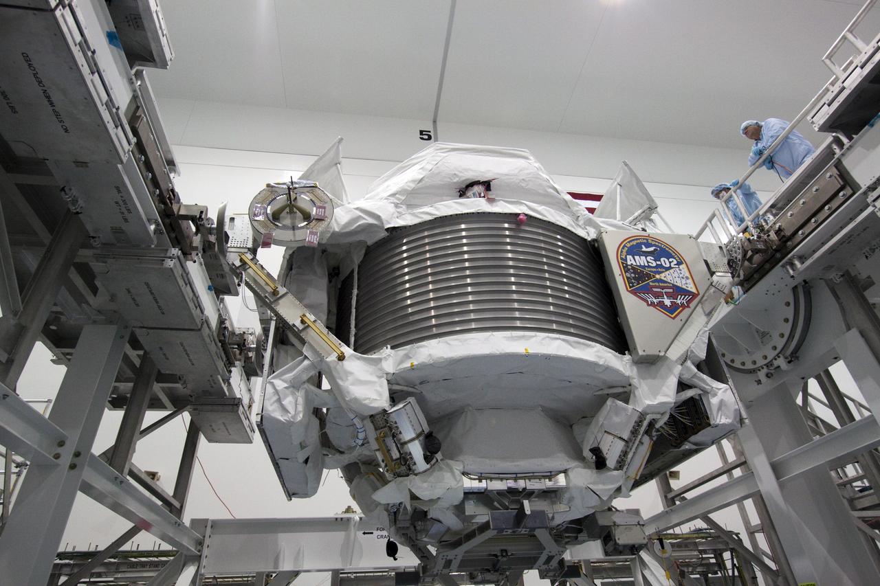 CAPE CANAVERAL, Fla. -- In the Space Station Processing Facility at NASA's Kennedy Space Center in Florida, the Alpha Magnetic Spectrometer-2 (AMS) will be rotated 180 degrees to provide better access for work to be performed on its avionics box. Technicians also will install a flight releasable grappling fixture to AMS while it is upside down. AMS is designed to operate as an external experiment on the International Space Station. It will use the unique environment of space to study the universe and its origin by searching for dark matter. AMS will fly to the station aboard space shuttle Endeavour's STS-134 mission targeted to launch Feb. 27, 2011. Photo credit: NASA/Jack Pfaller
