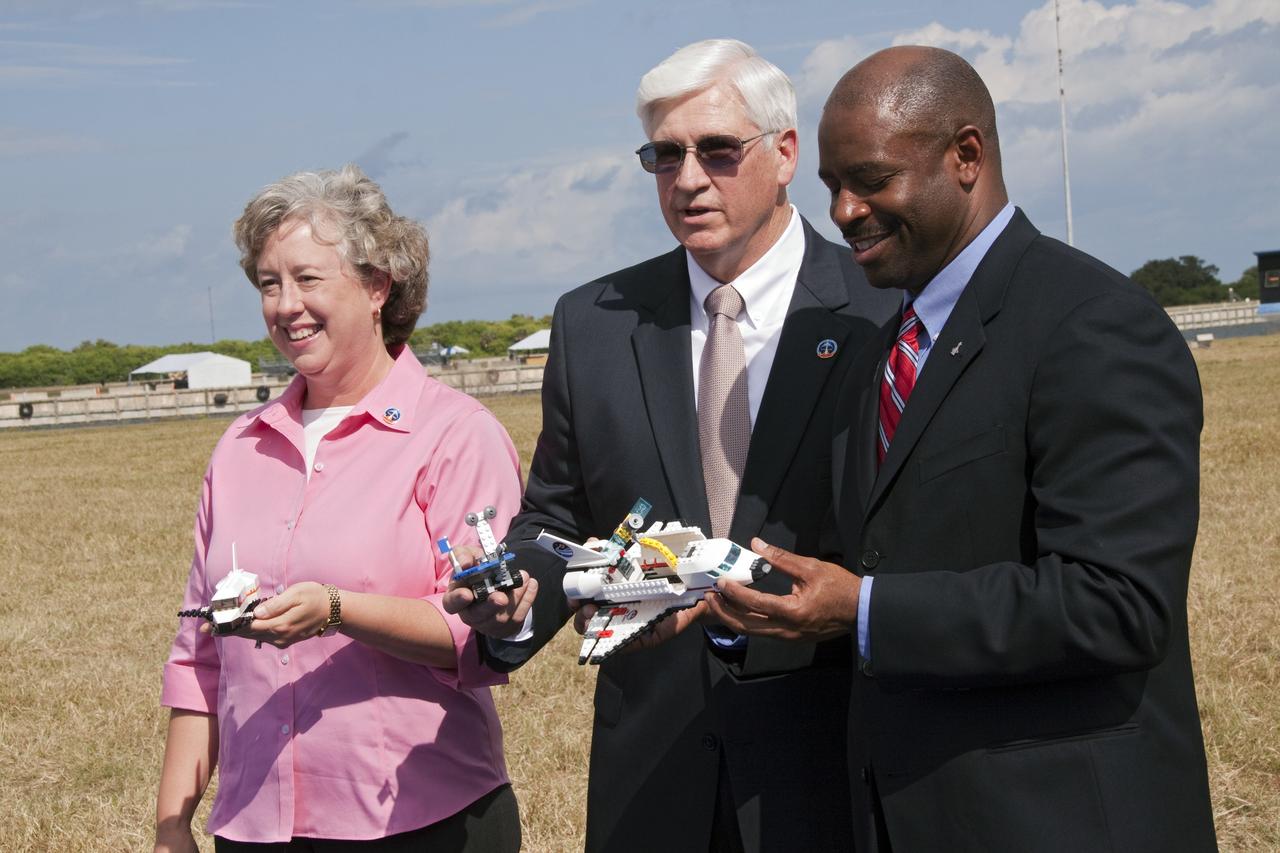 CAPE CANAVERAL, Fla. -- NASA and The LEGO Group announce a three-year Space Act Agreement meant to spark the interest of children in science, technology, engineering and mathematics (STEM) with the future release of four NASA-inspired products in the toy company's LEGO CITY line. From left, are Debbie Biggs, education specialist for International Space Station National Lab Education Projects, Stephan Turnipseed, president of LEGO Education North America, and Leland Melvin, NASA's associate administrator for Education.      To commemorate the beginning of the partnership, two small LEGO space shuttles will launch aboard space shuttle Discovery's STS-133 mission to the International Space Station. A 40- by 70-foot activity tent will be set up at Kennedy on Nov. 3 for children of all ages to build their vision of the future with LEGO bricks. LEGO sets also will fly to the space station aboard Endeavour's STS-134 mission, and will be put together on orbit to demonstrate the challenges faced while building things in microgravity. Photo credit: NASA/Jack Pfaller