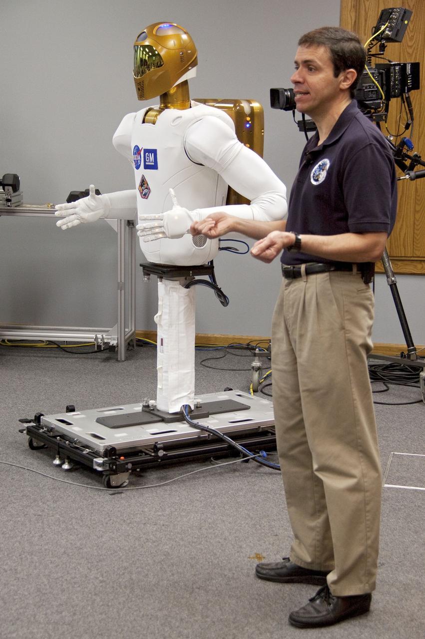 CAPE CANAVERAL, Fla. -- At NASA's Kennedy Space Center in Florida, Ron Diftler, NASA's Robonaut 2 (R2) project manager, shows media the capabilities of a dexterous humanoid astronaut helper. R2 will be delivered to the International Space Station on space shuttle Discovery's STS-133 mission. Although R2 will initially only participate in operational tests, upgrades could eventually allow the robot to realize its true purpose -- helping spacewalking astronauts with tasks outside the orbiting laboratory.        For more information on the upcoming STS-133 mission, visit www.nasa.gov/mission_pages/shuttle/shuttlemissions/sts133/. Photo credit: NASA/Jack Pfaller