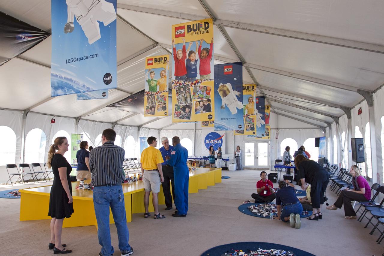 CAPE CANAVERAL, Fla. -- On the NASA Causeway at Kennedy Space Center in Florida, a 40- by 70-foot activity tent chock full of LEGO bricks is ready to welcome children of all ages. There, they will have the opportunity to build their vision of the future with LEGO bricks, marking the beginning of a three-year Space Act Agreement between NASA and The LEGO Group. The partnership is meant to spark the interest of children in science, technology, engineering and mathematics (STEM).         To commemorate the partnership, two small LEGO space shuttles will launch aboard space shuttle Discovery's STS-133 mission to the International Space Station and the company will release four NASA-inspired products in its LEGO CITY line next year. LEGO sets also will fly to the space station aboard Endeavour's STS-134 mission, and will be put together on orbit to demonstrate the challenges faced while building things in microgravity. Photo credit: NASA/Jack Pfaller