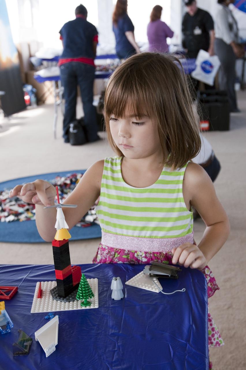 CAPE CANAVERAL, Fla. -- On the NASA Causeway at Kennedy Space Center in Florida, a 40- by 70-foot activity tent chock full of LEGO bricks hosts children and adults. There, they are building their vision of the future with LEGO bricks, marking the beginning of a three-year Space Act Agreement between NASA and The LEGO Group. The partnership is meant to spark the interest of children in science, technology, engineering and mathematics (STEM).           To commemorate the partnership, two small LEGO space shuttles will launch aboard space shuttle Discovery's STS-133 mission to the International Space Station and the company will release four NASA-inspired products in its LEGO CITY line next year. LEGO sets also will fly to the space station aboard Endeavour's STS-134 mission, and will be put together on orbit to demonstrate the challenges faced while building things in microgravity. Photo credit: NASA/Jack Pfaller