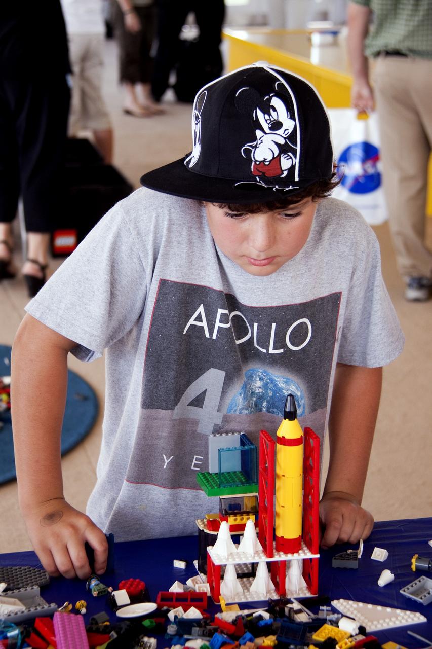CAPE CANAVERAL, Fla. -- On the NASA Causeway at Kennedy Space Center in Florida, a 40- by 70-foot activity tent chock full of LEGO bricks hosts children and adults. There, they are building their vision of the future with LEGO bricks, marking the beginning of a three-year Space Act Agreement between NASA and The LEGO Group. The partnership is meant to spark the interest of children in science, technology, engineering and mathematics (STEM).         To commemorate the partnership, two small LEGO space shuttles will launch aboard space shuttle Discovery's STS-133 mission to the International Space Station and the company will release four NASA-inspired products in its LEGO CITY line next year. LEGO sets also will fly to the space station aboard Endeavour's STS-134 mission, and will be put together on orbit to demonstrate the challenges faced while building things in microgravity. Photo credit: NASA/Jack Pfaller