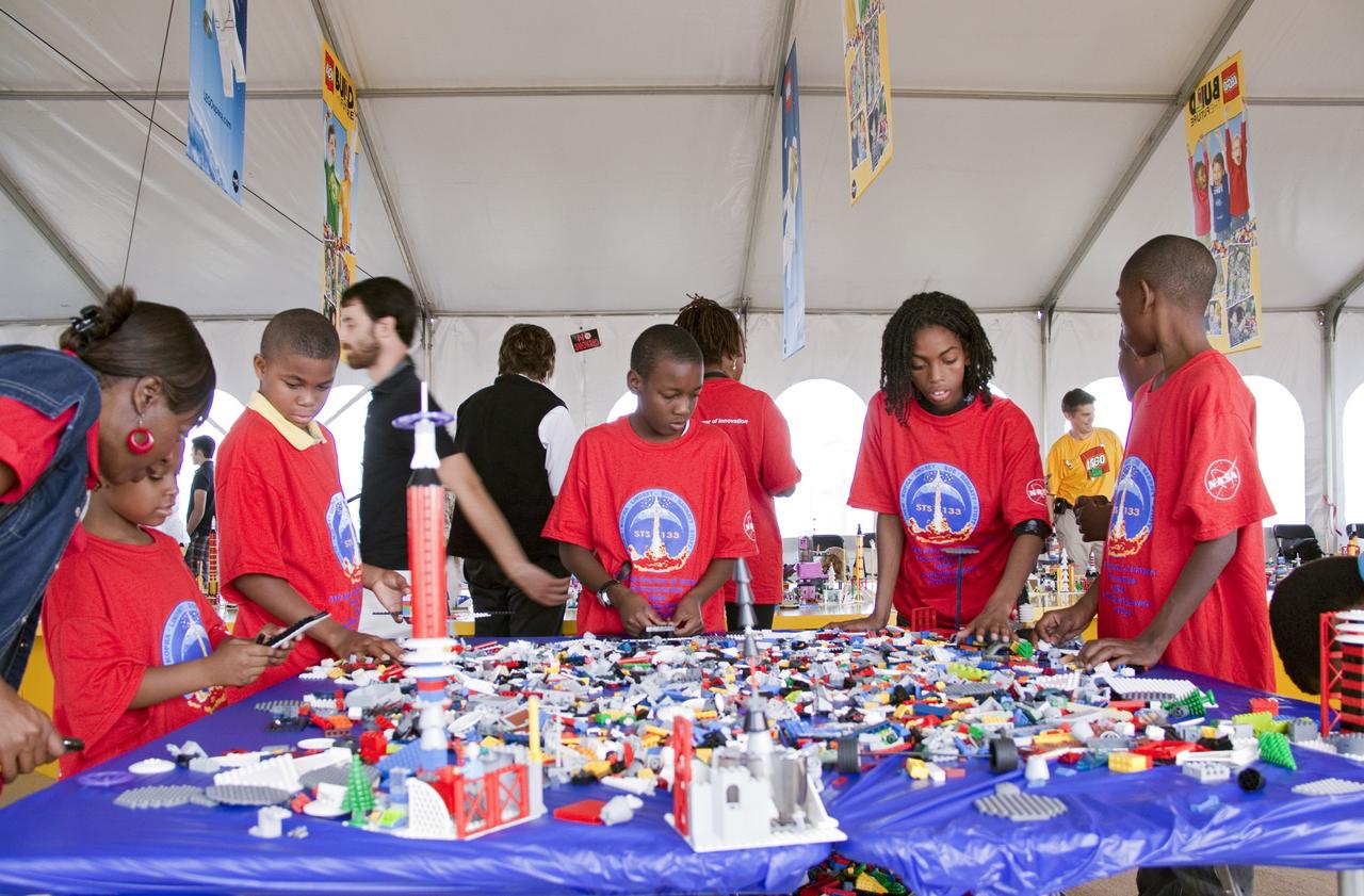CAPE CANAVERAL, Fla. -- On the NASA Causeway at Kennedy Space Center in Florida, school children build LEGO space vehicles inside a 40- by 70-foot activity tent. There, children of all ages are building their vision of the future with LEGO bricks, marking the beginning of a three-year Space Act Agreement between NASA and The LEGO Group. The partnership is meant to spark the interest of children in science, technology, engineering and mathematics (STEM).     To commemorate the partnership, two small LEGO space shuttles will launch aboard space shuttle Discovery's STS-133 mission to the International Space Station and the company will release four NASA-inspired products in its LEGO CITY line next year. LEGO sets also will fly to the space station aboard Endeavour's STS-134 mission, and will be put together on orbit to demonstrate the challenges faced while building things in microgravity. Photo credit: NASA/Jack Pfaller