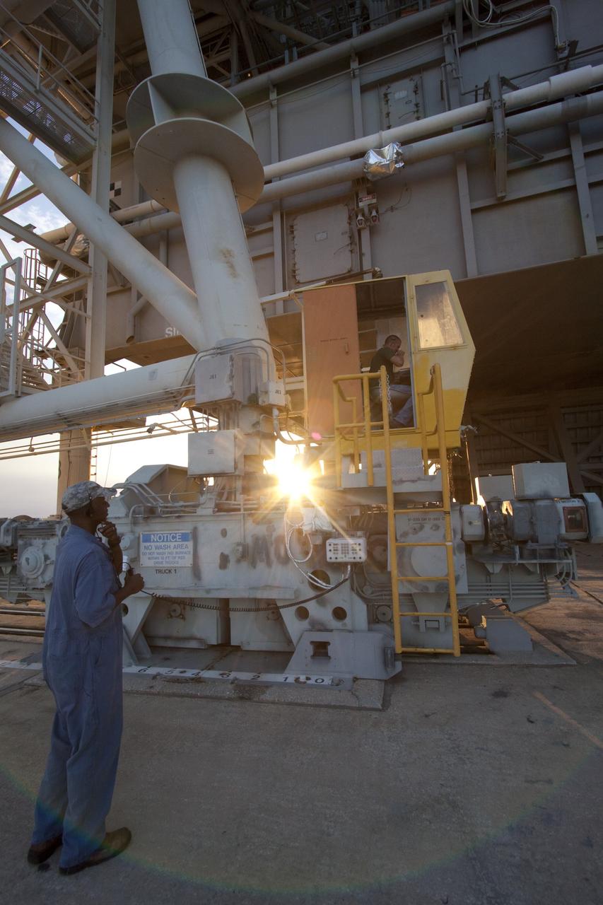 CAPE CANAVERAL, Fla. -- On Launch Pad 39A, technicians prepare to move the pad's rotating service structure away from space shuttle Discovery as the sun sets over NASA's Kennedy Space Center in Florida. The structure provides weather protection and access to the shuttle while it awaits lift off on the pad. RSS "rollback," as it's called, is a significant milestone in the launch countdown. Launch of Discovery on the STS-133 mission to the International Space Station is set for 3:29 p.m. on Nov. 4. During the 11-day mission, Discovery and its six crew members will deliver the Permanent Multipurpose Module, packed with supplies and critical spare parts, as well as Robonaut 2, to the orbiting laboratory. Discovery, which will fly its 39th mission, is scheduled to be retired following STS-133. This will be the 133rd Space Shuttle Program mission and the 35th shuttle voyage to the space station. For more information on STS-133, visit www.nasa.gov/mission_pages/shuttle/shuttlemissions/sts133/. Photo credit: NASA/Jack Pfaller