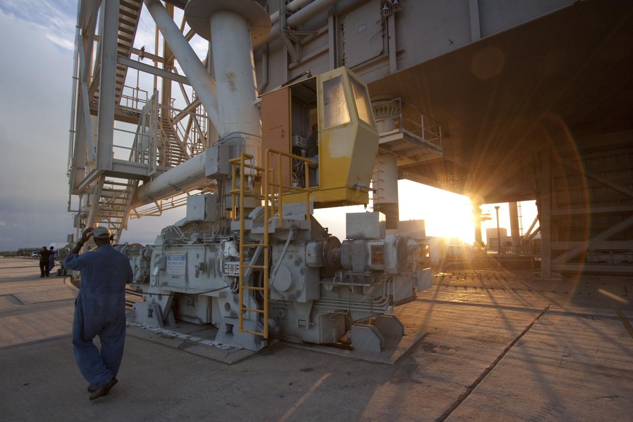CAPE CANAVERAL, Fla. -- On Launch Pad 39A, technicians prepare to move the pad's rotating service structure away from space shuttle Discovery as the sun sets over NASA's Kennedy Space Center in Florida. The structure provides weather protection and access to the shuttle while it awaits lift off on the pad. RSS "rollback," as it's called, is a significant milestone in the launch countdown. Launch of Discovery on the STS-133 mission to the International Space Station is set for 3:29 p.m. on Nov. 4. During the 11-day mission, Discovery and its six crew members will deliver the Permanent Multipurpose Module, packed with supplies and critical spare parts, as well as Robonaut 2, to the orbiting laboratory. Discovery, which will fly its 39th mission, is scheduled to be retired following STS-133. This will be the 133rd Space Shuttle Program mission and the 35th shuttle voyage to the space station. For more information on STS-133, visit www.nasa.gov/mission_pages/shuttle/shuttlemissions/sts133/. Photo credit: NASA/Jack Pfaller