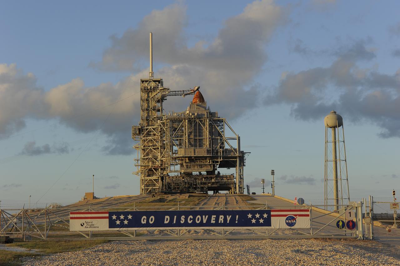 CAPE CANAVERAL, Fla. -- Before the sun sets on Launch Pad 39A at NASA's Kennedy Space Center in Florida, space shuttle Discovery is concealed by the pad's rotating service structure. The structure provides weather protection and access to the shuttle. RSS "rollback," as it's called, is a significant milestone in the launch countdown. Launch of Discovery on the STS-133 mission to the International Space Station is set for 3:29 p.m. on Nov. 4. During the 11-day mission, Discovery and its six crew members will deliver the Permanent Multipurpose Module, packed with supplies and critical spare parts, as well as Robonaut 2, to the orbiting laboratory. Discovery, which will fly its 39th mission, is scheduled to be retired following STS-133. This will be the 133rd Space Shuttle Program mission and the 35th shuttle voyage to the space station. For more information on STS-133, visit www.nasa.gov/mission_pages/shuttle/shuttlemissions/sts133/. Photo credit: NASA/Kim Shiflett