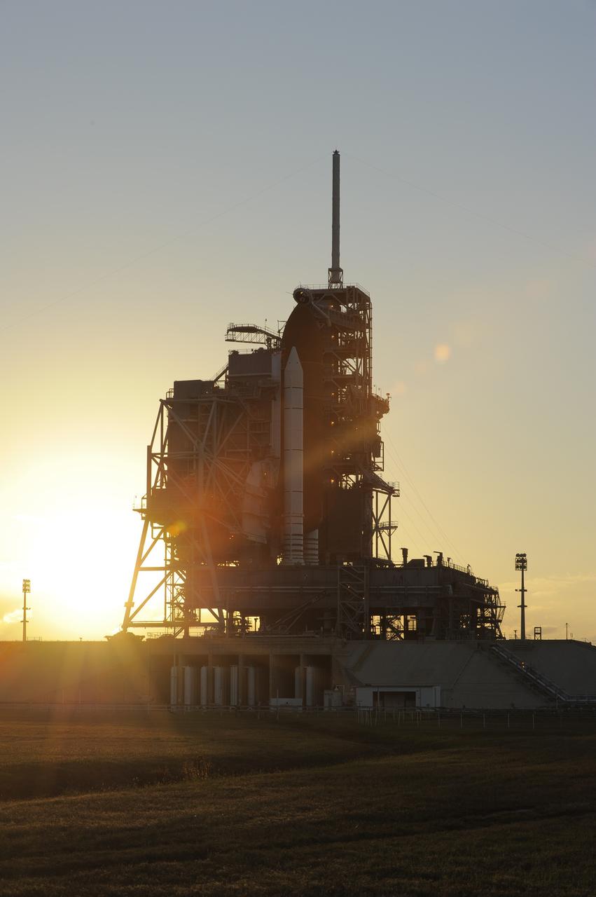 CAPE CANAVERAL, Fla. -- On Launch Pad 39A, preparations are under way to move the pad's rotating service structure away from space shuttle Discovery as the sun sets over NASA's Kennedy Space Center in Florida. The structure provides weather protection and access to the shuttle while it awaits lift off on the pad. RSS "rollback," as it's called, is a significant milestone in the launch countdown.         Launch of Discovery on the STS-133 mission to the International Space Station is set for 3:29 p.m. on Nov. 4. During the 11-day mission, Discovery and its six crew members will deliver the Permanent Multipurpose Module, packed with supplies and critical spare parts, as well as Robonaut 2, to the orbiting laboratory. Discovery, which will fly its 39th mission, is scheduled to be retired following STS-133. This will be the 133rd Space Shuttle Program mission and the 35th shuttle voyage to the space station. For more information on STS-133, visit www.nasa.gov/mission_pages/shuttle/shuttlemissions/sts133/. Photo credit: NASA/Kim Shiflett