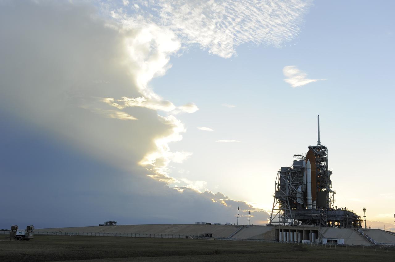 CAPE CANAVERAL, Fla. -- Storm clouds move in over Launch Pad 39A at NASA's Kennedy Space Center in Florida, postponing the retraction of the pad's rotating service structure, which would reveal space shuttle Discovery. The structure provides weather protection and access to the shuttle while it awaits lift off on the pad. RSS "rollback," as it's called, will begin again after the lightning-producing clouds pass.     Launch of Discovery on the STS-133 mission to the International Space Station is set for 3:29 p.m. on Nov. 4. During the 11-day mission, Discovery and its six crew members will deliver the Permanent Multipurpose Module, packed with supplies and critical spare parts, as well as Robonaut 2, to the orbiting laboratory. Discovery, which will fly its 39th mission, is scheduled to be retired following STS-133. This will be the 133rd Space Shuttle Program mission and the 35th shuttle voyage to the space station. For more information on STS-133, visit www.nasa.gov/mission_pages/shuttle/shuttlemissions/sts133/. Photo credit: NASA/Kim Shiflett