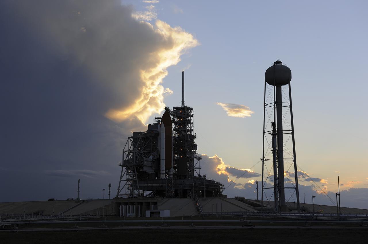 CAPE CANAVERAL, Fla. -- Storm clouds move over Launch Pad 39A at NASA's Kennedy Space Center in Florida, postponing the retraction of the pad's rotating service structure, which would reveal space shuttle Discovery. The structure provides weather protection and access to the shuttle while it awaits lift off on the pad. RSS "rollback," as it's called, will begin again after the lightning-producing clouds pass. Launch of Discovery on the STS-133 mission to the International Space Station is set for 3:29 p.m. on Nov. 4. During the 11-day mission, Discovery and its six crew members will deliver the Permanent Multipurpose Module, packed with supplies and critical spare parts, as well as Robonaut 2, to the orbiting laboratory. Discovery, which will fly its 39th mission, is scheduled to be retired following STS-133. This will be the 133rd Space Shuttle Program mission and the 35th shuttle voyage to the space station. For more information on STS-133, visit www.nasa.gov/mission_pages/shuttle/shuttlemissions/sts133/. Photo credit: NASA/Kim Shiflett