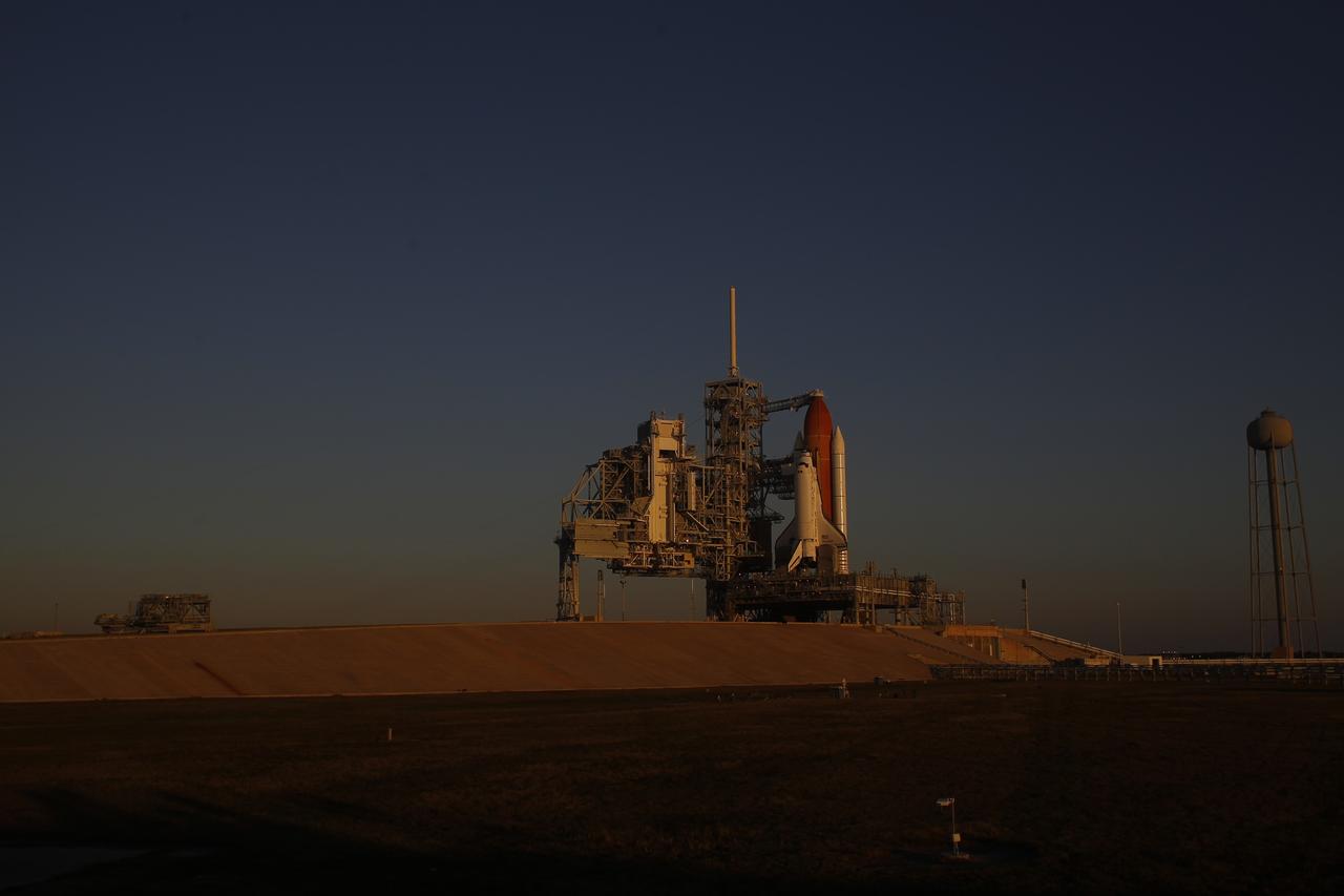 CAPE CANAVERAL, Fla. -- At NASA's Kennedy Space Center in Florida, space shuttle Discovery waits patiently on Launch Pad 39A for its STS-133 launch to the International Space Station. Managers scrubbed the Nov. 5 launch attempt because a hydrogen gas leak was detected at the Ground Umbilical Carrier Plate (GUCP) while Discovery's external fuel tank was being loaded. The GUCP is an attachment point between the external tank and a pipe that carries gaseous hydrogen safely away from the shuttle to the flare stack, where it is burned off. The next possible launch attempt would be Monday, Nov. 8, at 12:53 p.m. EST. After that, the launch window moves to Nov. 30 through Dec. 5.          During the 11-day mission, Discovery and its six crew members will deliver the Permanent Multipurpose Module, packed with supplies and critical spare parts, as well as Robonaut 2, to the orbiting laboratory. Discovery, which will fly its 39th mission, is scheduled to be retired following STS-133. This will be the 133rd Space Shuttle Program mission and the 35th shuttle voyage to the space station. For more information on STS-133, visit www.nasa.gov/mission_pages/shuttle/shuttlemissions/sts133/. Photo credit: NASA