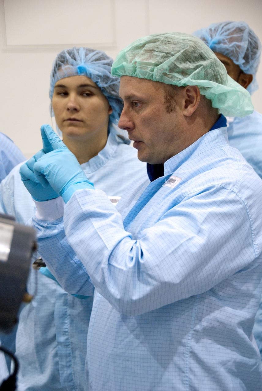 CAPE CANAVERAL, Fla. -- In the Space Station Processing Facility at NASA's Kennedy Space Center in Florida, STS-134 Mission Specialist Michael Finke, front right, checks out the Alpha Magnetic Spectrometer-2 (AMS) with the experiment's technicians. Finke and his five crewmates are at Kennedy participating in the Crew Equipment Interface Test (CEIT), which gives them an opportunity for hands-on training with tools they'll be using in space and familiarization of the payload they'll be delivering to the International Space Station.               Space shuttle Endeavour is targeted to launch on the STS-134 mission Feb. 27, 2011. For more information, visit www.nasa.gov/mission_pages/shuttle/shuttlemissions/sts134/index.html. Photo credit: NASA/Cory Huston
