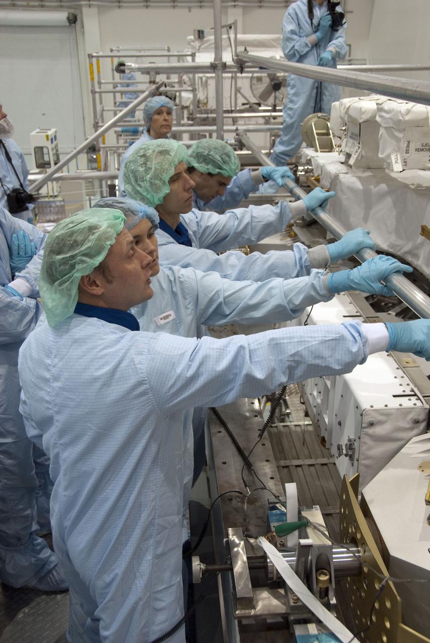CAPE CANAVERAL, Fla. -- In the Space Station Processing Facility at NASA's Kennedy Space Center in Florida, STS-134 crew members inspect the Express Logistics Carrier-3 with the carrier's technicians. The six-member crew is at Kennedy participating in the Crew Equipment Interface Test (CEIT), which gives them an opportunity for hands-on training with tools they'll be using in space and familiarization of the payload they'll be delivering to the International Space Station.               Space shuttle Endeavour is targeted to launch on the STS-134 mission Feb. 27, 2011. For more information, visit www.nasa.gov/mission_pages/shuttle/shuttlemissions/sts134/index.html. Photo credit: NASA/Cory Huston