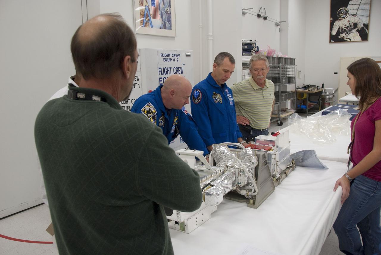 CAPE CANAVERAL, Fla. -- In the Space Station Processing Facility at NASA's Kennedy Space Center in Florida, STS-134 Commander Mark Kelly and Mission Specialist Andrew Feustel check out some of the tools and equipment they'll be using in space. The six-member crew is at Kennedy participating in the Crew Equipment Interface Test (CEIT), which gives them an opportunity for hands-on training and familiarization of the payload they'll be delivering to the International Space Station.                Space shuttle Endeavour is targeted to launch on the STS-134 mission Feb. 27, 2011. For more information, visit www.nasa.gov/mission_pages/shuttle/shuttlemissions/sts134/index.html. Photo credit: NASA/Cory Huston