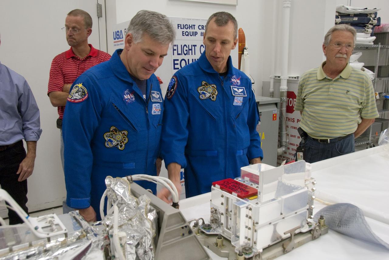 CAPE CANAVERAL, Fla. -- In the Space Station Processing Facility at NASA's Kennedy Space Center in Florida, STS-134 Pilot Gregory H. Johnson and Mission Specialist Andrew Feustel check out some of the tools and equipment they'll be using in space. The six-member crew is at Kennedy participating in the Crew Equipment Interface Test (CEIT), which gives them an opportunity for hands-on training and familiarization of the payload they'll be delivering to the International Space Station.                Space shuttle Endeavour is targeted to launch on the STS-134 mission Feb. 27, 2011. For more information, visit www.nasa.gov/mission_pages/shuttle/shuttlemissions/sts134/index.html. Photo credit: NASA/Cory Huston