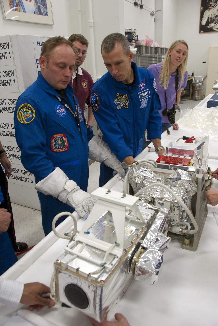 CAPE CANAVERAL, Fla. -- In the Space Station Processing Facility at NASA's Kennedy Space Center in Florida, STS-134 Mission Specialists Michael Finke and Andrew Feustel check out some of the tools and equipment they'll be using in space. The six-member crew is at Kennedy participating in the Crew Equipment Interface Test (CEIT), which gives them an opportunity for hands-on training and familiarization of the payload they'll be delivering to the International Space Station.                  Space shuttle Endeavour is targeted to launch on the STS-134 mission Feb. 27, 2011. For more information, visit www.nasa.gov/mission_pages/shuttle/shuttlemissions/sts134/index.html. Photo credit: NASA/Cory Huston