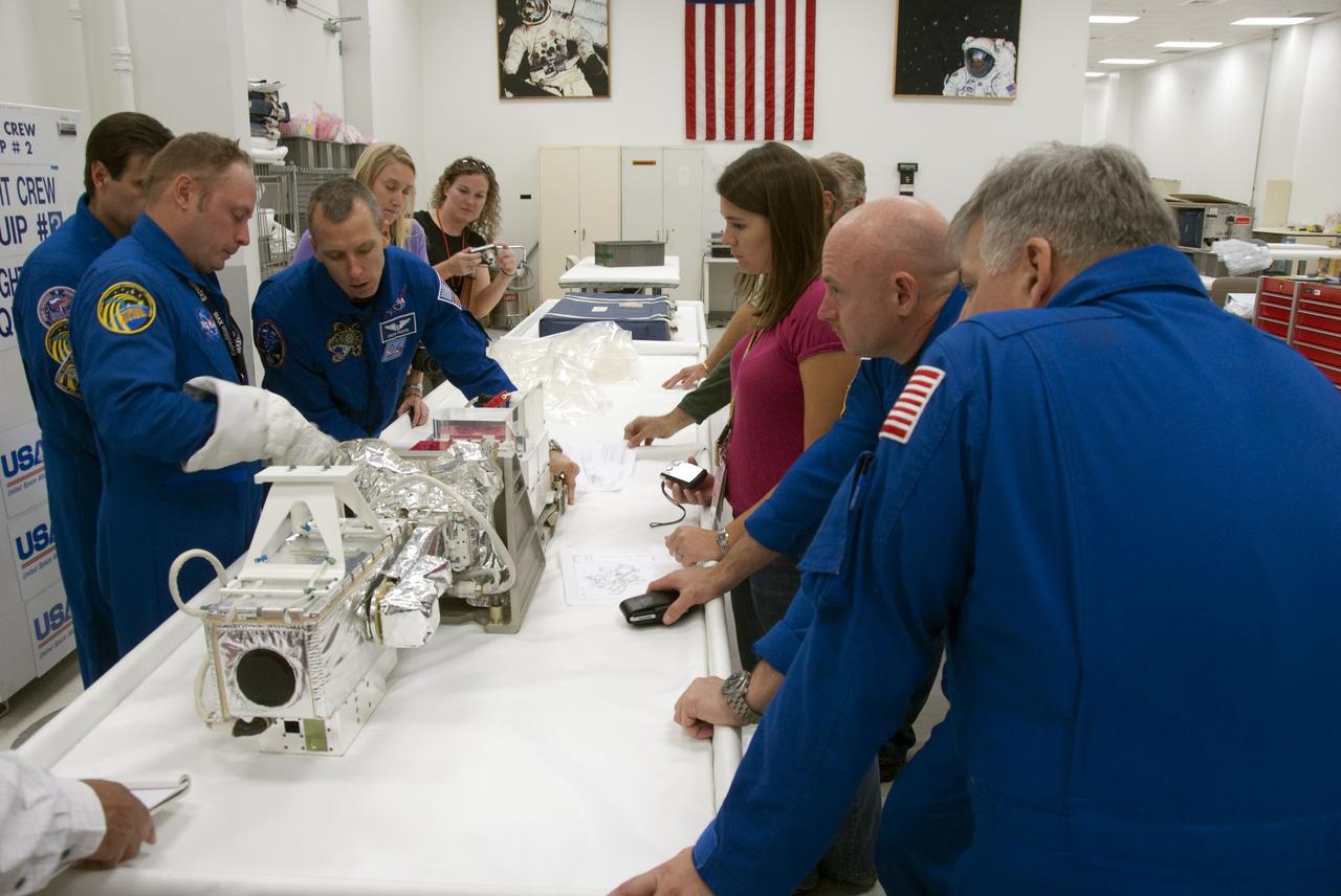 CAPE CANAVERAL, Fla. -- In the Space Station Processing Facility at NASA's Kennedy Space Center in Florida, STS-134 crew members check out some of the tools and equipment they'll be using in space. The six-member crew is at Kennedy participating in the Crew Equipment Interface Test (CEIT), which gives them an opportunity for hands-on training and familiarization of the payload they'll be delivering to the International Space Station.                  Space shuttle Endeavour is targeted to launch on the STS-134 mission Feb. 27, 2011. For more information, visit www.nasa.gov/mission_pages/shuttle/shuttlemissions/sts134/index.html. Photo credit: NASA/Cory Huston