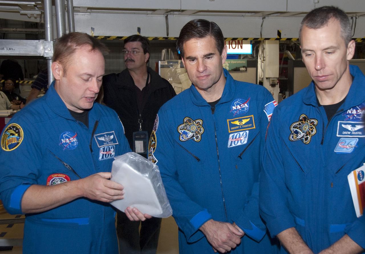 CAPE CANAVERAL, Fla. -- In the Orbiter Processing Facility-2 at NASA's Kennedy Space Center in Florida, STS-134 Mission Specialists Michael Finke, left, Gregory Chamitoff and Andrew Feustel check out the heat shield tiles that protect space shuttles during re-entry. The six STS-134 astronauts are at Kennedy participating in the Crew Equipment Interface Test (CEIT), which gives them an opportunity for hands-on training with the tools and equipment they'll use in space and familiarization of the payload they'll be delivering to the International Space Station. Space shuttle Endeavour is targeted to launch on the STS-134 mission Feb. 27, 2011. For more information, visit www.nasa.gov/mission_pages/shuttle/shuttlemissions/sts134/index.html. Photo credit: NASA/Cory Huston