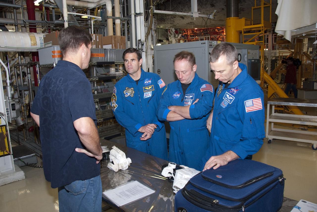 CAPE CANAVERAL, Fla. -- In the Orbiter Processing Facility-2 at NASA's Kennedy Space Center in Florida, STS-134 Mission Specialists Greg Chamitoff, left, Michael Finke and Andrew Feustel check out the camera they'll be snapping photos with in space. The six STS-134 astronauts are at Kennedy participating in the Crew Equipment Interface Test (CEIT), which gives them an opportunity for hands-on training and familiarization of the payload they'll be delivering to the International Space Station. Space shuttle Endeavour is targeted to launch on the STS-134 mission Feb. 27, 2011. For more information, visit www.nasa.gov/mission_pages/shuttle/shuttlemissions/sts134/index.html. Photo credit: NASA/Cory Huston