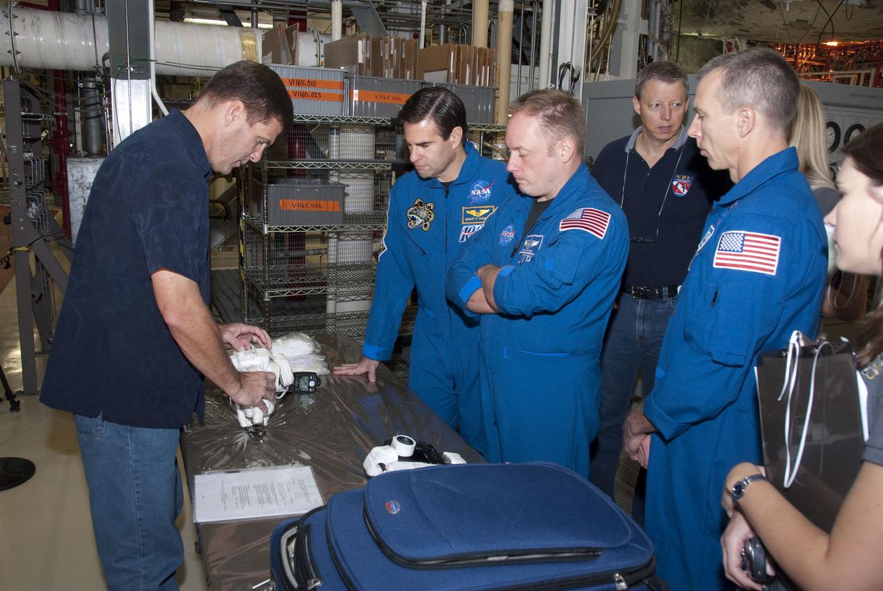 CAPE CANAVERAL, Fla. -- In the Orbiter Processing Facility-2 at NASA's Kennedy Space Center in Florida, STS-134 Mission Specialists Greg Chamitoff, left, Michael Finke and Andrew Feustel check out the camera they'll be snapping photos with in space. The six STS-134 astronauts are at Kennedy participating in the Crew Equipment Interface Test (CEIT), which gives them an opportunity for hands-on training and familiarization of the payload they'll be delivering to the International Space Station. Space shuttle Endeavour is targeted to launch on the STS-134 mission Feb. 27, 2011. For more information, visit www.nasa.gov/mission_pages/shuttle/shuttlemissions/sts134/index.html. Photo credit: NASA/Cory Huston