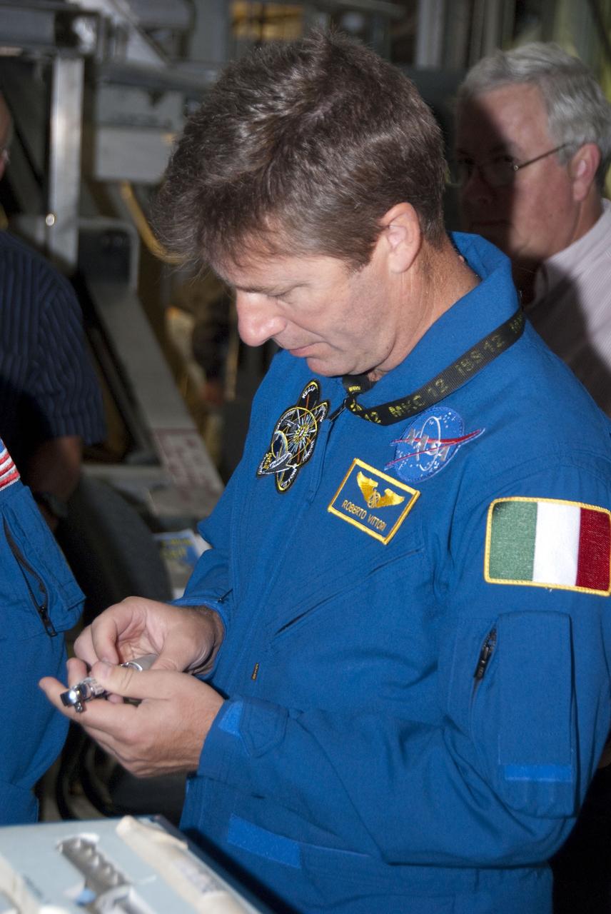 CAPE CANAVERAL, Fla. -- In the Orbiter Processing Facility-2 at NASA's Kennedy Space Center in Florida, STS-134 Mission Specialist Roberto Vittori with the European Space Agency checks out a tool he'll be using in space. The six STS-134 astronauts are at Kennedy participating in the Crew Equipment Interface Test (CEIT), which gives them an opportunity for hands-on training and familiarization of the payload they'll be delivering to the International Space Station. Space shuttle Endeavour is targeted to launch on the STS-134 mission Feb. 27, 2011. For more information, visit www.nasa.gov/mission_pages/shuttle/shuttlemissions/sts134/index.html. Photo credit: NASA/Cory Huston