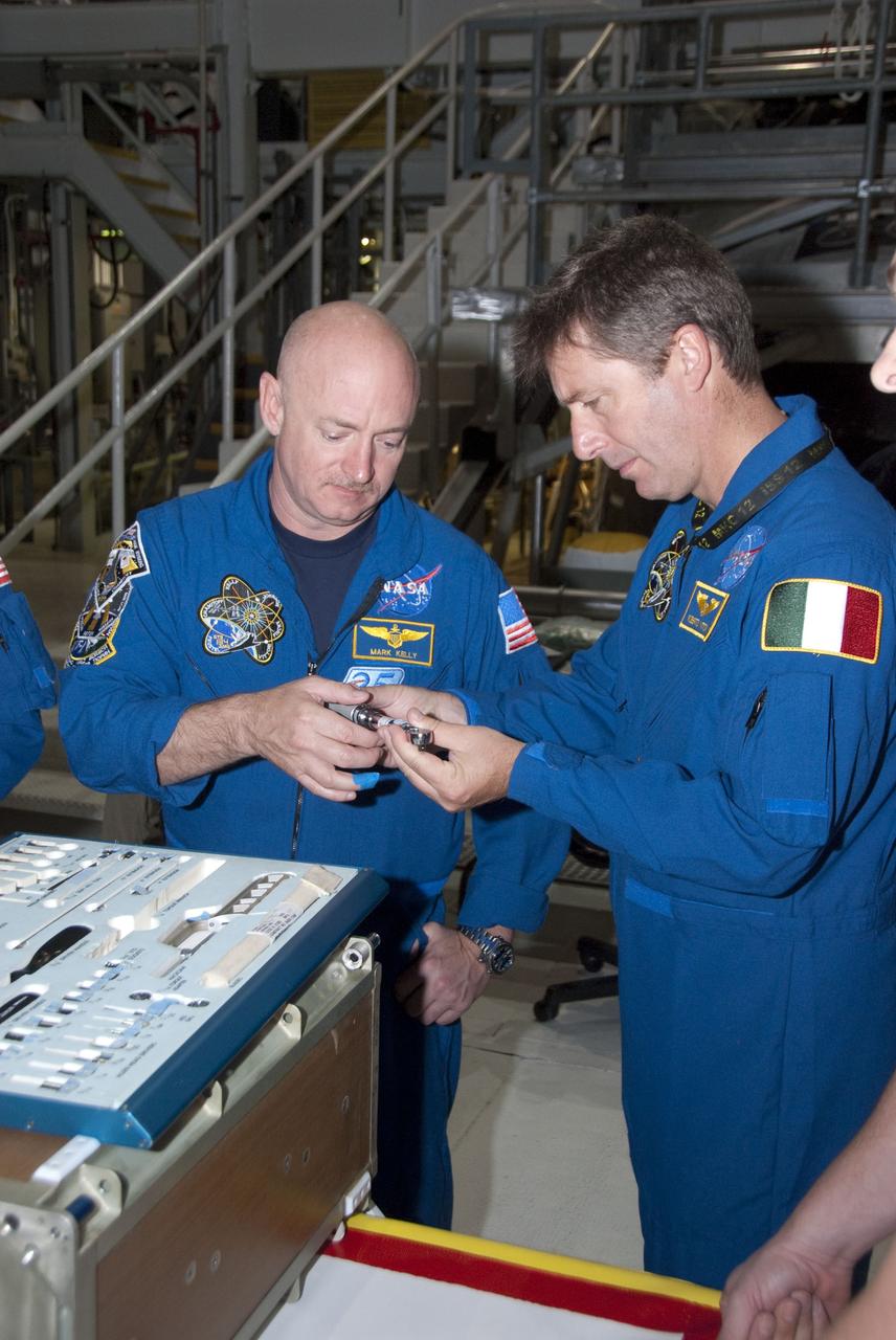 CAPE CANAVERAL, Fla. -- In the Orbiter Processing Facility-2 at NASA's Kennedy Space Center in Florida, STS-134 Commander Mark Kelly, left, and Mission Specialist Roberto Vittori with the European Space Agency check out a tool they'll be using in space. The six STS-134 astronauts are at Kennedy participating in the Crew Equipment Interface Test (CEIT), which gives them an opportunity for hands-on training and familiarization of the payload they'll be delivering to the International Space Station. Space shuttle Endeavour is targeted to launch on the STS-134 mission Feb. 27, 2011. For more information, visit www.nasa.gov/mission_pages/shuttle/shuttlemissions/sts134/index.html. Photo credit: NASA/Cory Huston