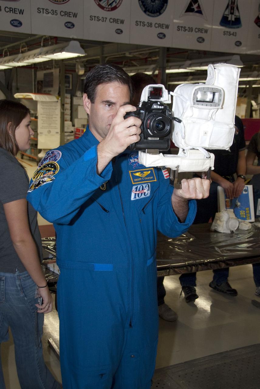 CAPE CANAVERAL, Fla. -- In the Orbiter Processing Facility-2 at NASA's Kennedy Space Center in Florida, STS-134 Mission Specialist Greg Chamitoff practices using a camera he'll be snapping photos with in space. The six STS-134 astronauts are at Kennedy participating in the Crew Equipment Interface Test (CEIT), which gives them an opportunity for hands-on training and familiarization of the payload they'll be delivering to the International Space Station. Space shuttle Endeavour is targeted to launch on the STS-134 mission Feb. 27, 2011. For more information, visit www.nasa.gov/mission_pages/shuttle/shuttlemissions/sts134/index.html. Photo credit: NASA/Cory Huston