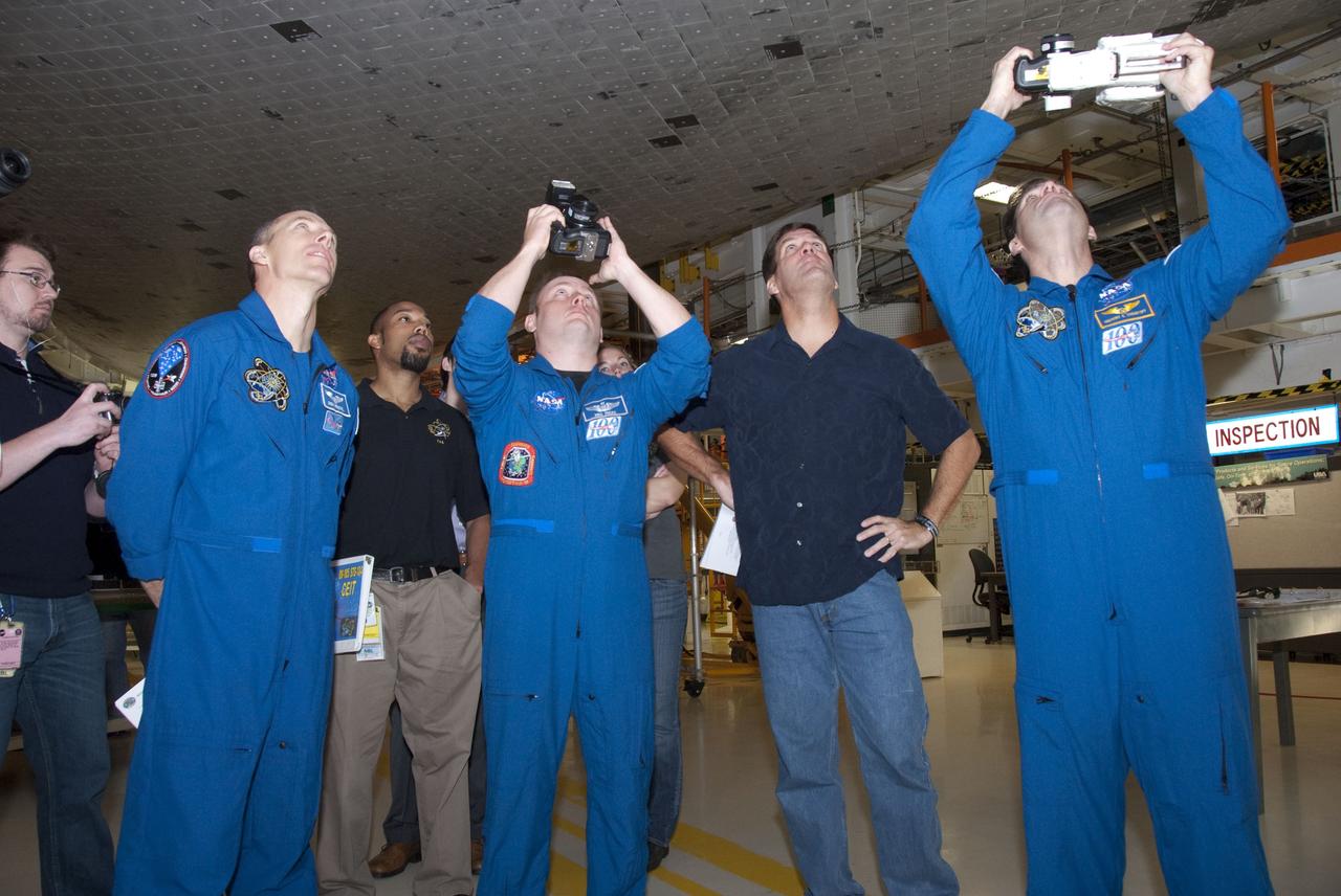 CAPE CANAVERAL, Fla. -- In the Orbiter Processing Facility-2 at NASA's Kennedy Space Center in Florida, STS-134 Mission Specialists Andrew Feustel, left, Michael Finke and Greg Chamitoff look at space shuttle Endeavour's heat shield tiles, which will protect the spacecraft during re-entry. The six STS-134 astronauts are at Kennedy participating in the Crew Equipment Interface Test (CEIT), which gives them an opportunity for hands-on training and familiarization of the payload they'll be delivering to the International Space Station. Space shuttle Endeavour is targeted to launch on the STS-134 mission Feb. 27, 2011. For more information, visit www.nasa.gov/mission_pages/shuttle/shuttlemissions/sts134/index.html. Photo credit: NASA/Cory Huston