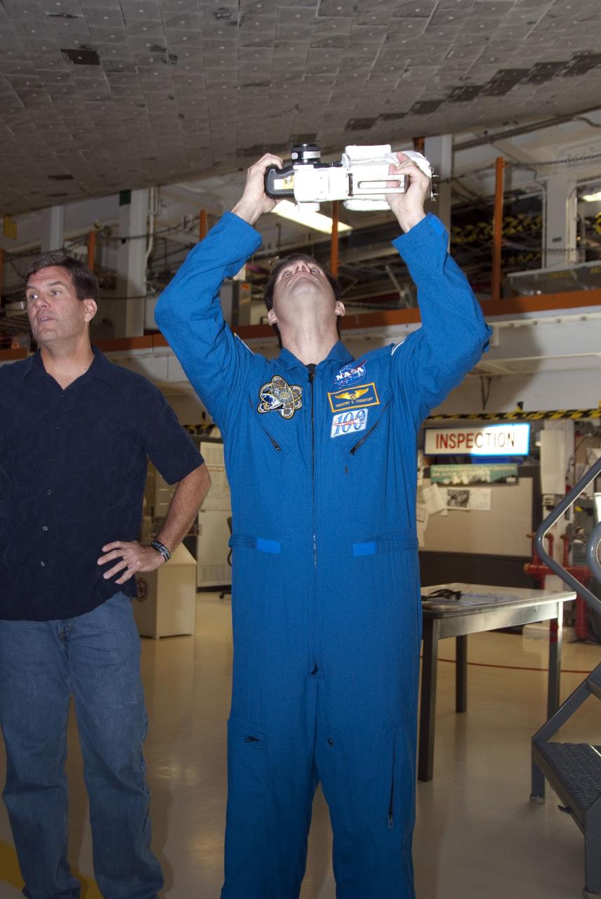 CAPE CANAVERAL, Fla. -- In the Orbiter Processing Facility-2 at NASA's Kennedy Space Center in Florida, STS-134 Mission Specialist Greg Chamitoff looks at space shuttle Endeavour's heat shield tiles, which will protect the spacecraft during re-entry. The six STS-134 astronauts are at Kennedy participating in the Crew Equipment Interface Test (CEIT), which gives them an opportunity for hands-on training and familiarization of the payload they'll be delivering to the International Space Station. Space shuttle Endeavour is targeted to launch on the STS-134 mission Feb. 27, 2011. For more information, visit www.nasa.gov/mission_pages/shuttle/shuttlemissions/sts134/index.html. Photo credit: NASA/Cory Huston