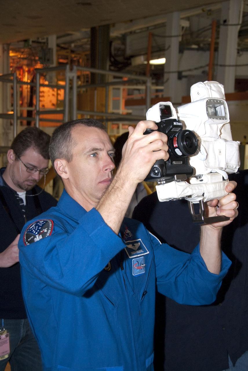 CAPE CANAVERAL, Fla. -- In the Orbiter Processing Facility-2 at NASA's Kennedy Space Center in Florida, STS-134 Mission Specialist Andrew Feustel practices using a camera he'll be snapping photos with in space. The six STS-134 astronauts are at Kennedy participating in the Crew Equipment Interface Test (CEIT), which gives them an opportunity for hands-on training and familiarization of the payload they'll be delivering to the International Space Station. Space shuttle Endeavour is targeted to launch on the STS-134 mission Feb. 27, 2011. For more information, visit www.nasa.gov/mission_pages/shuttle/shuttlemissions/sts134/index.html. Photo credit: NASA/Cory Huston