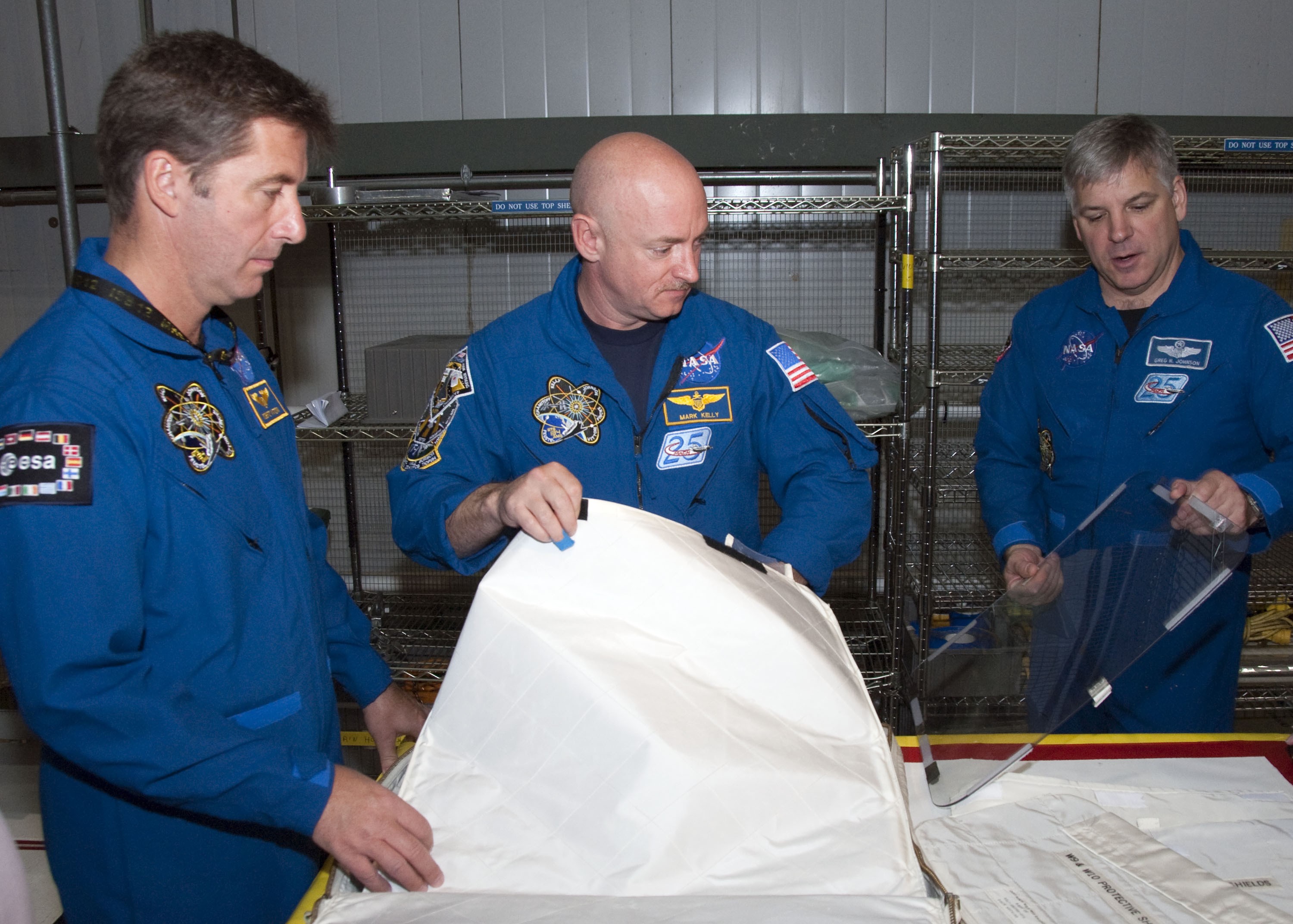 CAPE CANAVERAL, Fla. -- In the Orbiter Processing Facility-2 at NASA's Kennedy Space Center in Florida, STS-134 Mission Specialist Roberto Vittori with the European Space Agency, left, Commander Mark Kelly and Pilot Gregory H. Johnson check out tools and equipment they'll be using in space. The six STS-134 astronauts are at Kennedy participating in the Crew Equipment Interface Test (CEIT), which gives them an opportunity for hands-on training and familiarization of the payload they'll be delivering to the International Space Station. Space shuttle Endeavour is targeted to launch on the STS-134 mission Feb. 27, 2011. For more information, visit www.nasa.gov/mission_pages/shuttle/shuttlemissions/sts134/index.html. Photo credit: NASA/Cory Huston