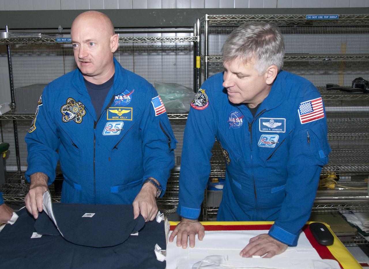 CAPE CANAVERAL, Fla. -- In the Orbiter Processing Facility-2 at NASA's Kennedy Space Center in Florida, STS-134 Commander Mark Kelly, left, and Pilot Gregory H. Johnson check out tools and equipment they'll be using in space. The six STS-134 astronauts are at Kennedy participating in the Crew Equipment Interface Test (CEIT), which gives them an opportunity for hands-on training and familiarization of the payload they'll be delivering to the International Space Station. Space shuttle Endeavour is targeted to launch on the STS-134 mission Feb. 27, 2011. For more information, visit www.nasa.gov/mission_pages/shuttle/shuttlemissions/sts134/index.html. Photo credit: NASA/Cory Huston