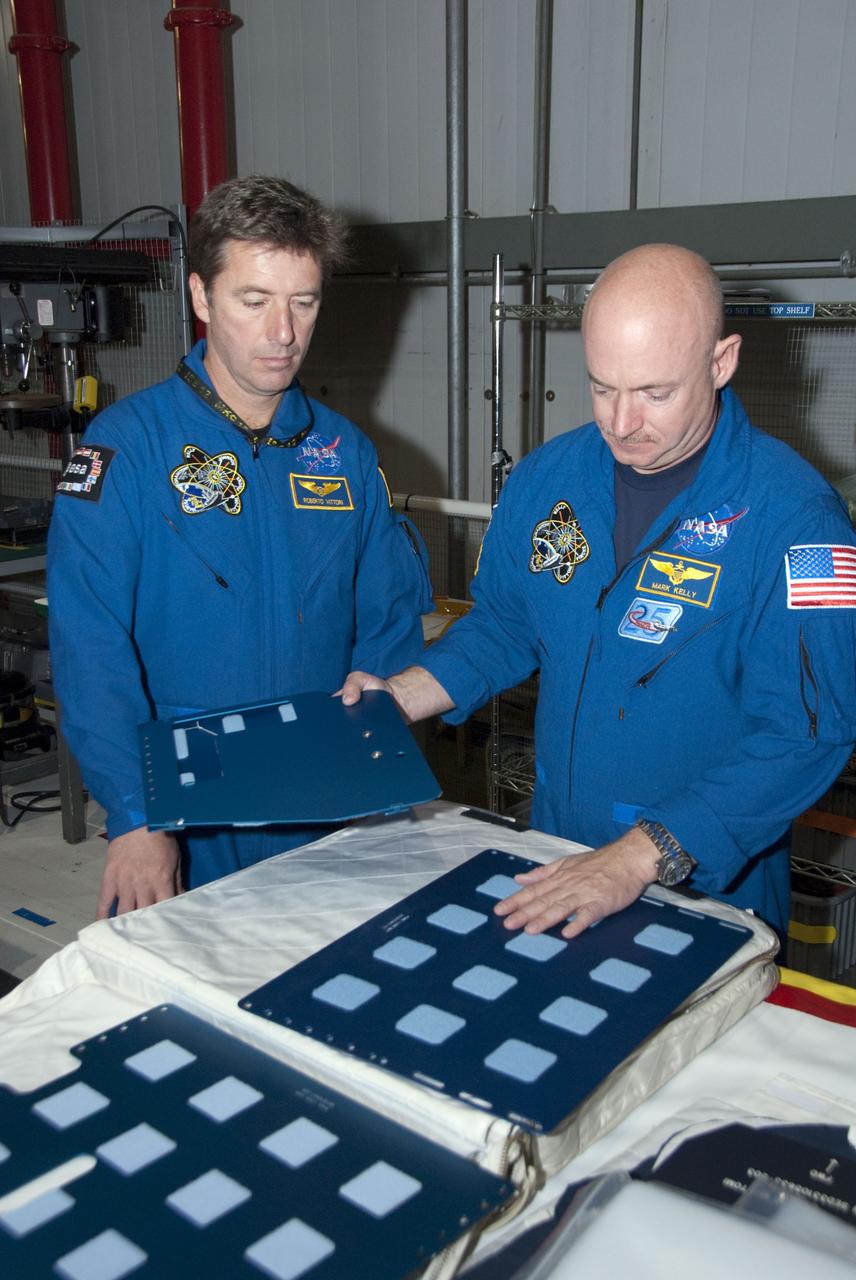 CAPE CANAVERAL, Fla. -- In the Orbiter Processing Facility-2 at NASA's Kennedy Space Center in Florida, STS-134 Mission Specialist Roberto Vittori with the European Space Agency, left, and Commander Mark Kelly check out tools and equipment they'll be using in space. The six STS-134 astronauts are at Kennedy participating in the Crew Equipment Interface Test (CEIT), which gives them an opportunity for hands-on training and familiarization of the payload they'll be delivering to the International Space Station. Space shuttle Endeavour is targeted to launch on the STS-134 mission Feb. 27, 2011. For more information, visit www.nasa.gov/mission_pages/shuttle/shuttlemissions/sts134/index.html. Photo credit: NASA/Cory Huston