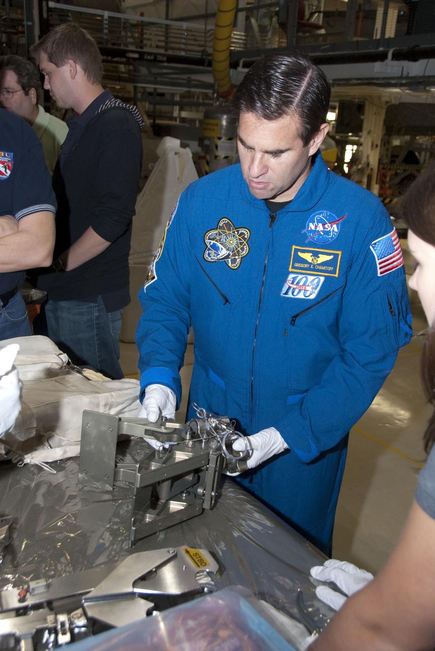 CAPE CANAVERAL, Fla. -- In the Orbiter Processing Facility-2 at NASA's Kennedy Space Center in Florida, STS-134 Mission Specialist Greg Chamitoff check outs tools and equipment he'll be using in space. The six STS-134 astronauts are at Kennedy participating in the Crew Equipment Interface Test (CEIT), which gives them an opportunity for hands-on training and familiarization of the payload they'll be delivering to the International Space Station. Space shuttle Endeavour is targeted to launch on the STS-134 mission Feb. 27, 2011. For more information, visit www.nasa.gov/mission_pages/shuttle/shuttlemissions/sts134/index.html. Photo credit: NASA/Cory Huston