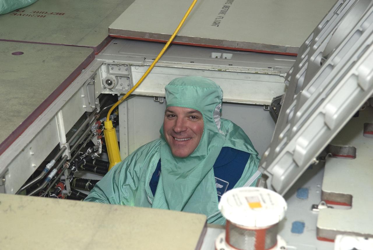 CAPE CANAVERAL, Fla. -- In Orbiter Processing Facility-2 at NASA's Kennedy Space Center in Florida, STS-134 Pilot Gregory H. Johnson checks space shuttle Endeavour's payload bay for sharp edges that could affect his work in space. The six STS-134 astronauts are participating in the Crew Equipment Interface Test (CEIT), which gives them an opportunity for hands-on training with the tools and equipment they'll use in space and familiarization of the payload they'll be delivering to the International Space Station.         Endeavour is targeted to launch on the STS-134 mission Feb. 27, 2011. For more information, visit www.nasa.gov/mission_pages/shuttle/shuttlemissions/sts134/index.html. Photo credit: NASA/Cory Huston and Glenn Benson