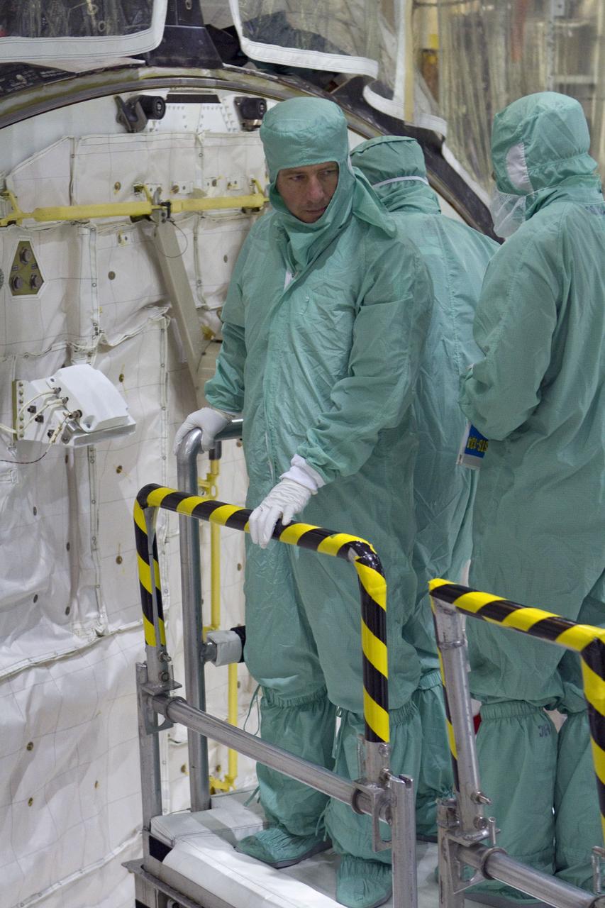 CAPE CANAVERAL, Fla. -- In Orbiter Processing Facility-2 at NASA's Kennedy Space Center in Florida, STS-134 Mission Specialist Roberto Vittori with the European Space Agency, his crewmates and technicians check space shuttle Endeavour's payload bay for sharp edges that could affect the astronauts' work in space. The six STS-134 astronauts are participating in the Crew Equipment Interface Test (CEIT), which gives them an opportunity for hands-on training with the tools and equipment they'll use in space and familiarization of the payload they'll be delivering to the International Space Station.     Endeavour is targeted to launch on the STS-134 mission Feb. 27, 2011. For more information, visit www.nasa.gov/mission_pages/shuttle/shuttlemissions/sts134/index.html. Photo credit: NASA/Cory Huston and Glenn Benson