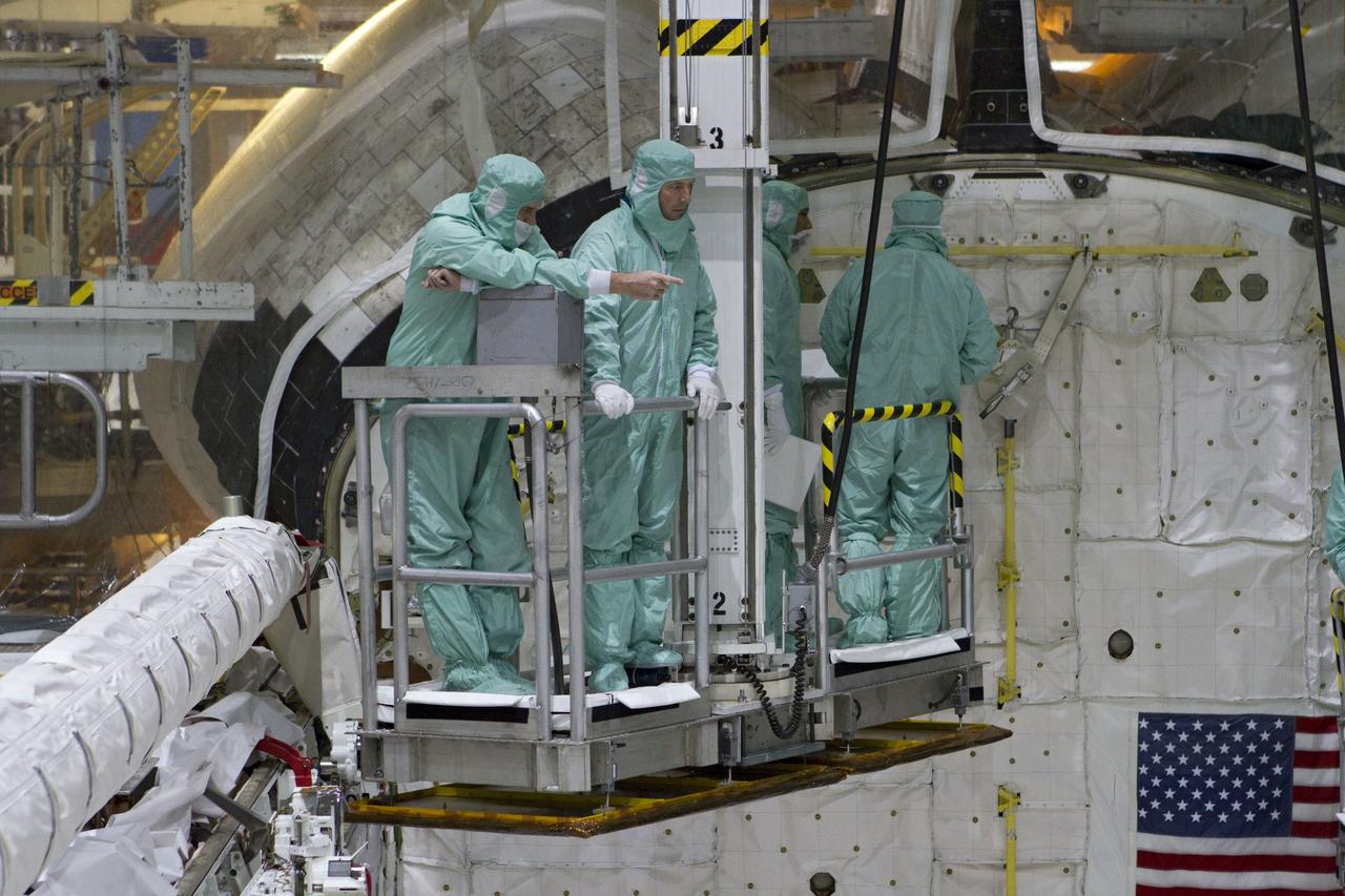 CAPE CANAVERAL, Fla. -- In Orbiter Processing Facility-2 at NASA's Kennedy Space Center in Florida, the STS-134 crew and technicians check space shuttle Endeavour's payload bay for sharp edges that could affect the astronauts' work in space. Seen here, from left, are a technician, Roberto Vittori with the European Space Agency, and another technician and astronaut. The six STS-134 astronauts are participating in the Crew Equipment Interface Test (CEIT), which gives them an opportunity for hands-on training with the tools and equipment they'll use in space and familiarization of the payload they'll be delivering to the International Space Station.         Endeavour is targeted to launch on the STS-134 mission Feb. 27, 2011. For more information, visit www.nasa.gov/mission_pages/shuttle/shuttlemissions/sts134/index.html. Photo credit: NASA/Cory Huston and Glenn Benson