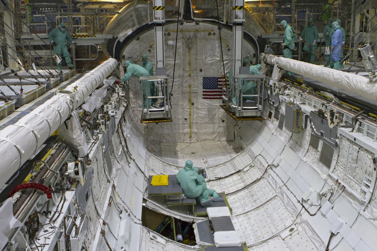 CAPE CANAVERAL, Fla. -- In Orbiter Processing Facility-2 at NASA's Kennedy Space Center in Florida, the STS-134 crew and technicians check space shuttle Endeavour's payload bay for sharp edges that could affect the astronauts' work in space. The six STS-134 astronauts are participating in the Crew Equipment Interface Test (CEIT), which gives them an opportunity for hands-on training with the tools and equipment they'll use in space and familiarization of the payload they'll be delivering to the International Space Station.       Endeavour is targeted to launch on the STS-134 mission Feb. 27, 2011. For more information, visit www.nasa.gov/mission_pages/shuttle/shuttlemissions/sts134/index.html. Photo credit: NASA/Cory Huston and Glenn Benson