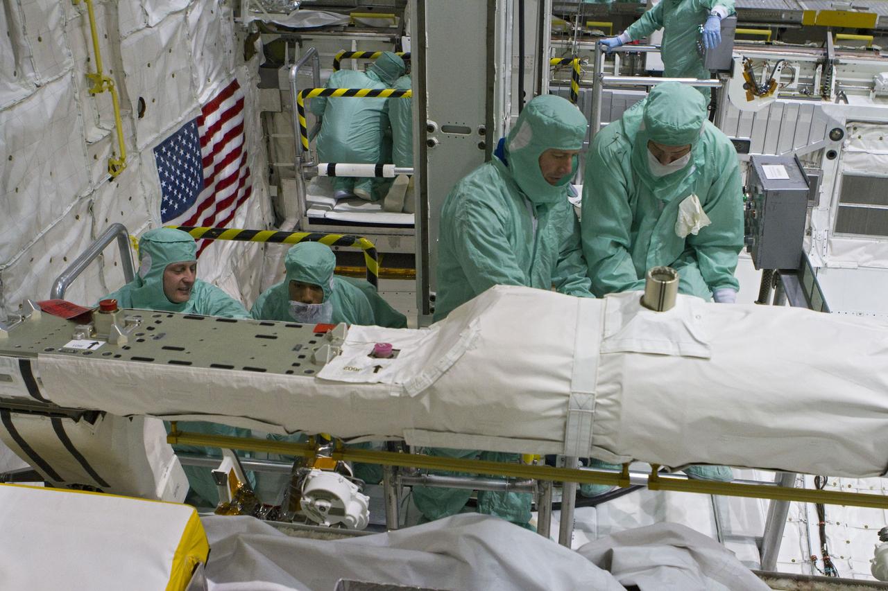 CAPE CANAVERAL, Fla. -- In Orbiter Processing Facility-2 at NASA's Kennedy Space Center in Florida, the STS-134 crew and technicians check space shuttle Endeavour's payload bay for sharp edges that could affect the astronauts' work in space. Seen here, from left, are Mission Specialist Michael Finke, a technician, Mission Specialist Roberto Vittori with the European Space Agency, and another technician. The six STS-134 astronauts are participating in the Crew Equipment Interface Test (CEIT), which gives them an opportunity for hands-on training with the tools and equipment they'll use in space and familiarization of the payload they'll be delivering to the International Space Station.     Endeavour is targeted to launch on the STS-134 mission Feb. 27, 2011. For more information, visit www.nasa.gov/mission_pages/shuttle/shuttlemissions/sts134/index.html. Photo credit: NASA/Cory Huston and Glenn Benson