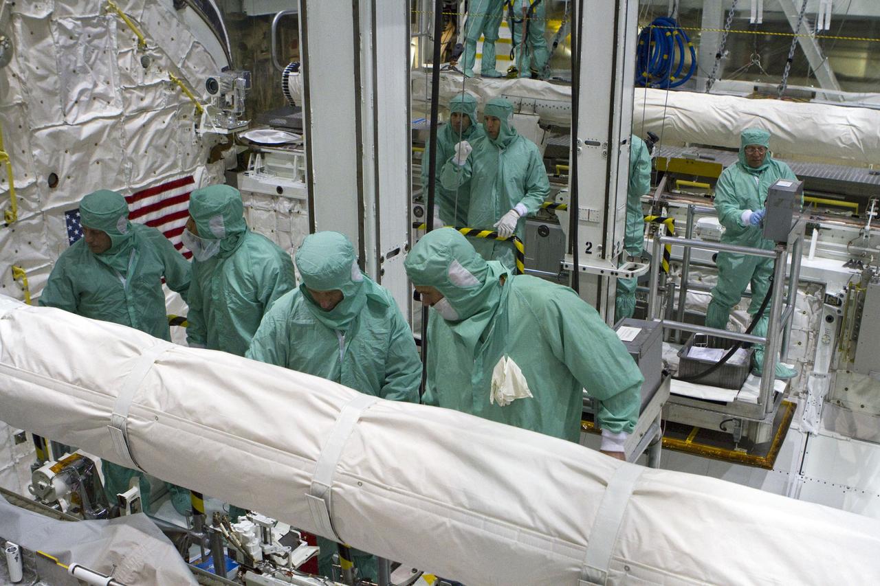 CAPE CANAVERAL, Fla. -- In Orbiter Processing Facility-2 at NASA's Kennedy Space Center in Florida, the STS-134 crew and technicians check space shuttle Endeavour's payload bay for sharp edges that could affect the astronauts' work in space. Seen here, from left, are Mission Specialist Michael Finke, a technician, Mission Specialist Roberto Vittori with the European Space Agency, and another technician. Behind them, from left, are Mission Specialists Greg Chamitoff and Andrew Feustel, and two technicians. The six STS-134 astronauts are participating in the Crew Equipment Interface Test (CEIT), which gives them an opportunity for hands-on training with the tools and equipment they'll use in space and familiarization of the payload they'll be delivering to the International Space Station.       Endeavour is targeted to launch on the STS-134 mission Feb. 27, 2011. For more information, visit www.nasa.gov/mission_pages/shuttle/shuttlemissions/sts134/index.html. Photo credit: NASA/Cory Huston and Glenn Benson