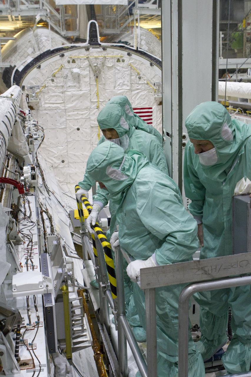 CAPE CANAVERAL, Fla. -- In Orbiter Processing Facility-2 at NASA's Kennedy Space Center in Florida, the STS-134 crew and technicians check space shuttle Endeavour's payload bay for sharp edges that could affect the astronauts' work in space. The six STS-134 astronauts are participating in the Crew Equipment Interface Test (CEIT), which gives them an opportunity for hands-on training with the tools and equipment they'll use in space and familiarization of the payload they'll be delivering to the International Space Station.   Endeavour is targeted to launch on the STS-134 mission Feb. 27, 2011. For more information, visit www.nasa.gov/mission_pages/shuttle/shuttlemissions/sts134/index.html. Photo credit: NASA/Cory Huston and Glenn Benson