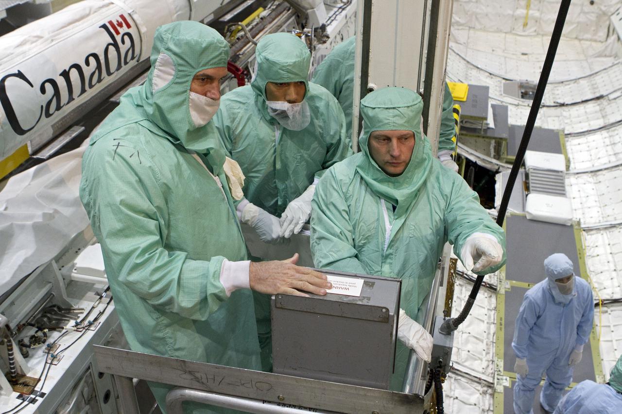CAPE CANAVERAL, Fla. -- In Orbiter Processing Facility-2 at NASA's Kennedy Space Center in Florida, the STS-134 crew and technicians check space shuttle Endeavour's payload bay for sharp edges that could affect the astronauts' work in space. Seen here, from left, are two technicians and Mission Specialist Michael Finke. The six STS-134 astronauts are participating in the Crew Equipment Interface Test (CEIT), which gives them an opportunity for hands-on training with the tools and equipment they'll use in space and familiarization of the payload they'll be delivering to the International Space Station.           Endeavour is targeted to launch on the STS-134 mission Feb. 27, 2011. For more information, visit www.nasa.gov/mission_pages/shuttle/shuttlemissions/sts134/index.html. Photo credit: NASA/Cory Huston and Glenn Benson