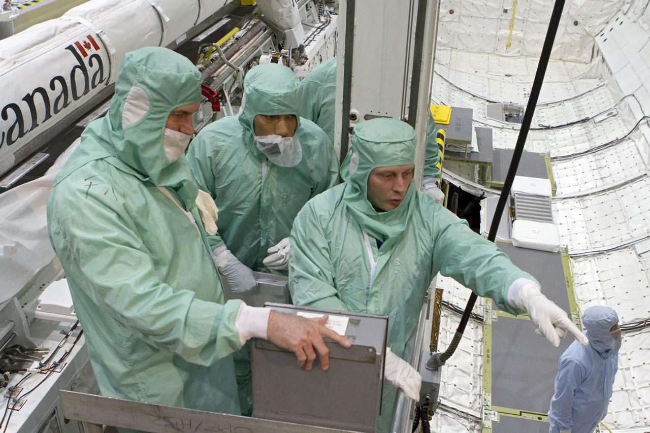 CAPE CANAVERAL, Fla. -- In Orbiter Processing Facility-2 at NASA's Kennedy Space Center in Florida, the STS-134 crew and technicians check space shuttle Endeavour's payload bay for sharp edges that could affect the astronauts' work in space. Seen here, from left, are two technicians and Mission Specialist Michael Finke. The six STS-134 astronauts are participating in the Crew Equipment Interface Test (CEIT), which gives them an opportunity for hands-on training with the tools and equipment they'll use in space and familiarization of the payload they'll be delivering to the International Space Station.         Endeavour is targeted to launch on the STS-134 mission Feb. 27, 2011. For more information, visit www.nasa.gov/mission_pages/shuttle/shuttlemissions/sts134/index.html. Photo credit: NASA/Cory Huston and Glenn Benson